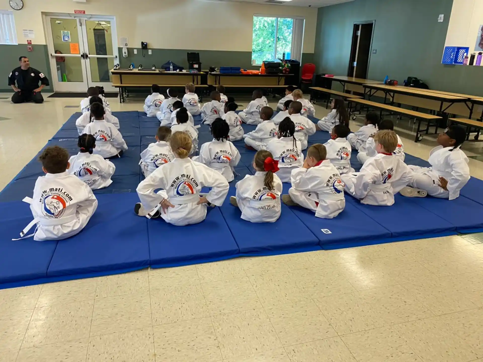 a group of people sitting on the floor in a room