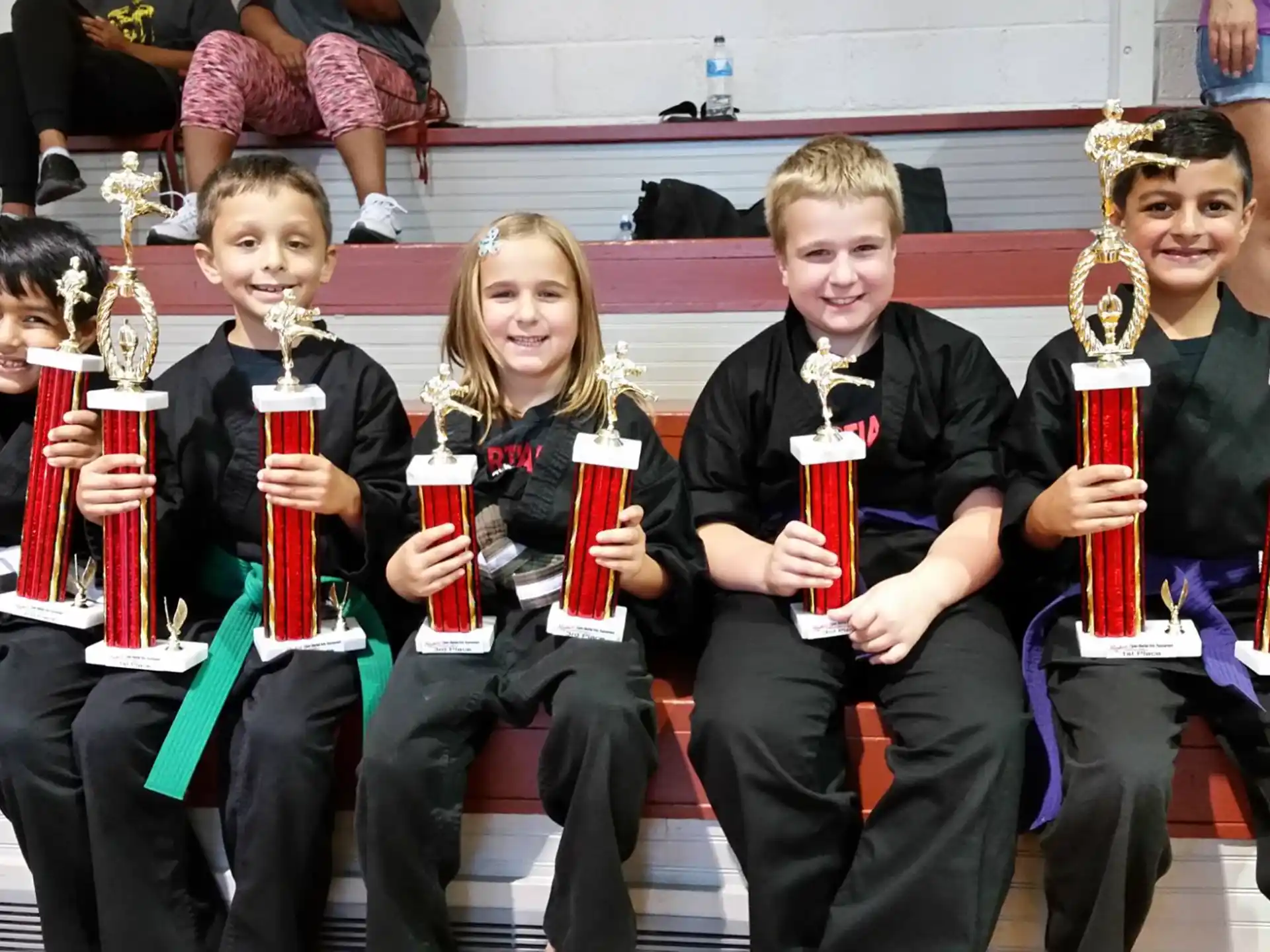 a group of people holding trophies
