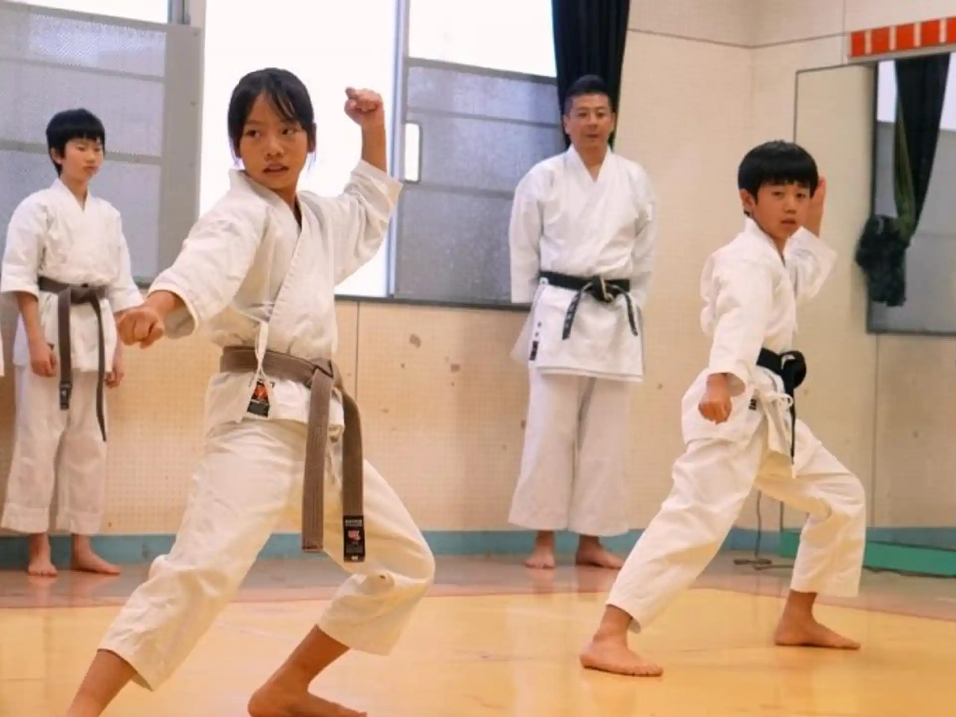 a group of people in karate uniforms