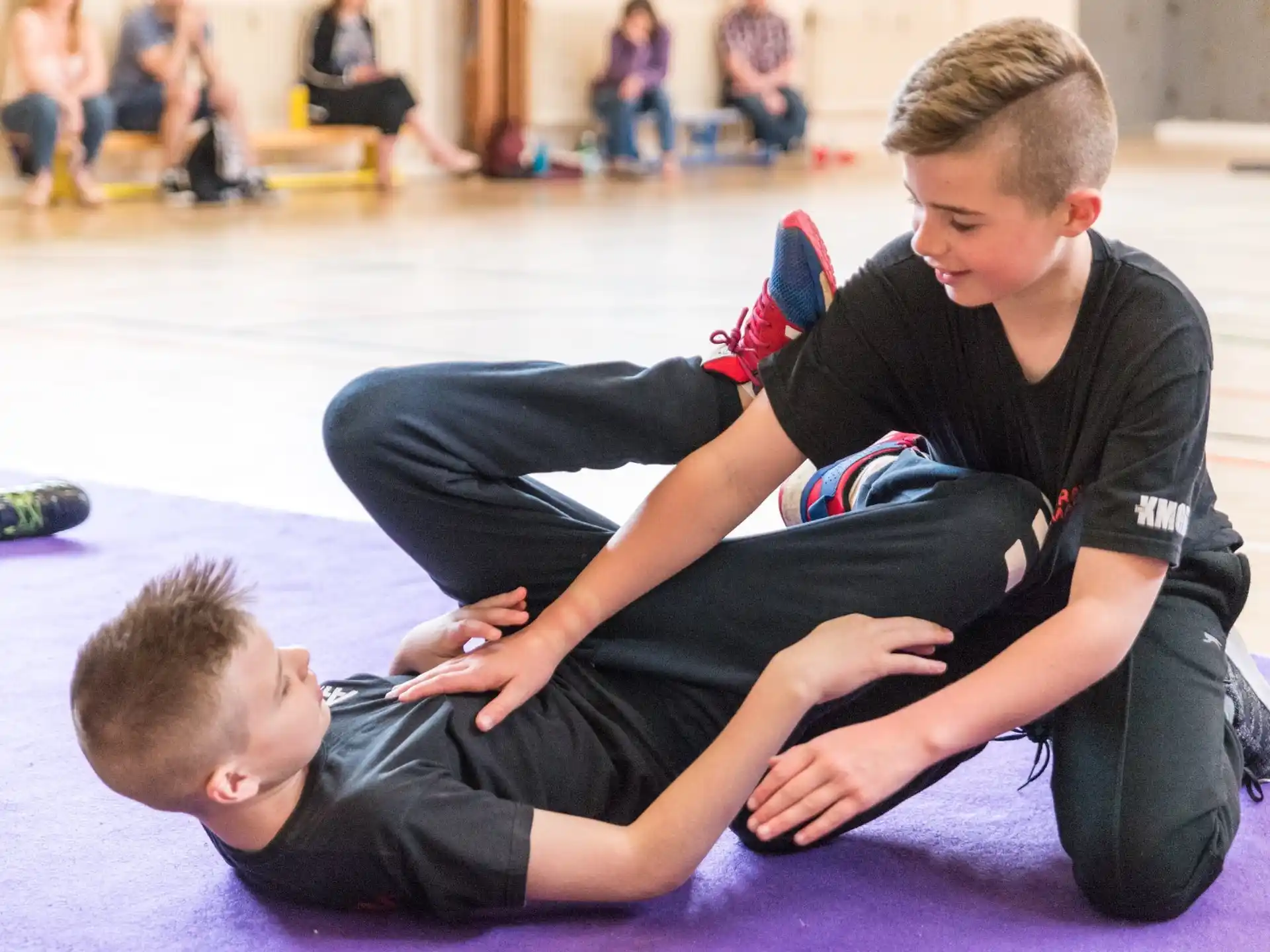 a boy and girl sitting on the floor