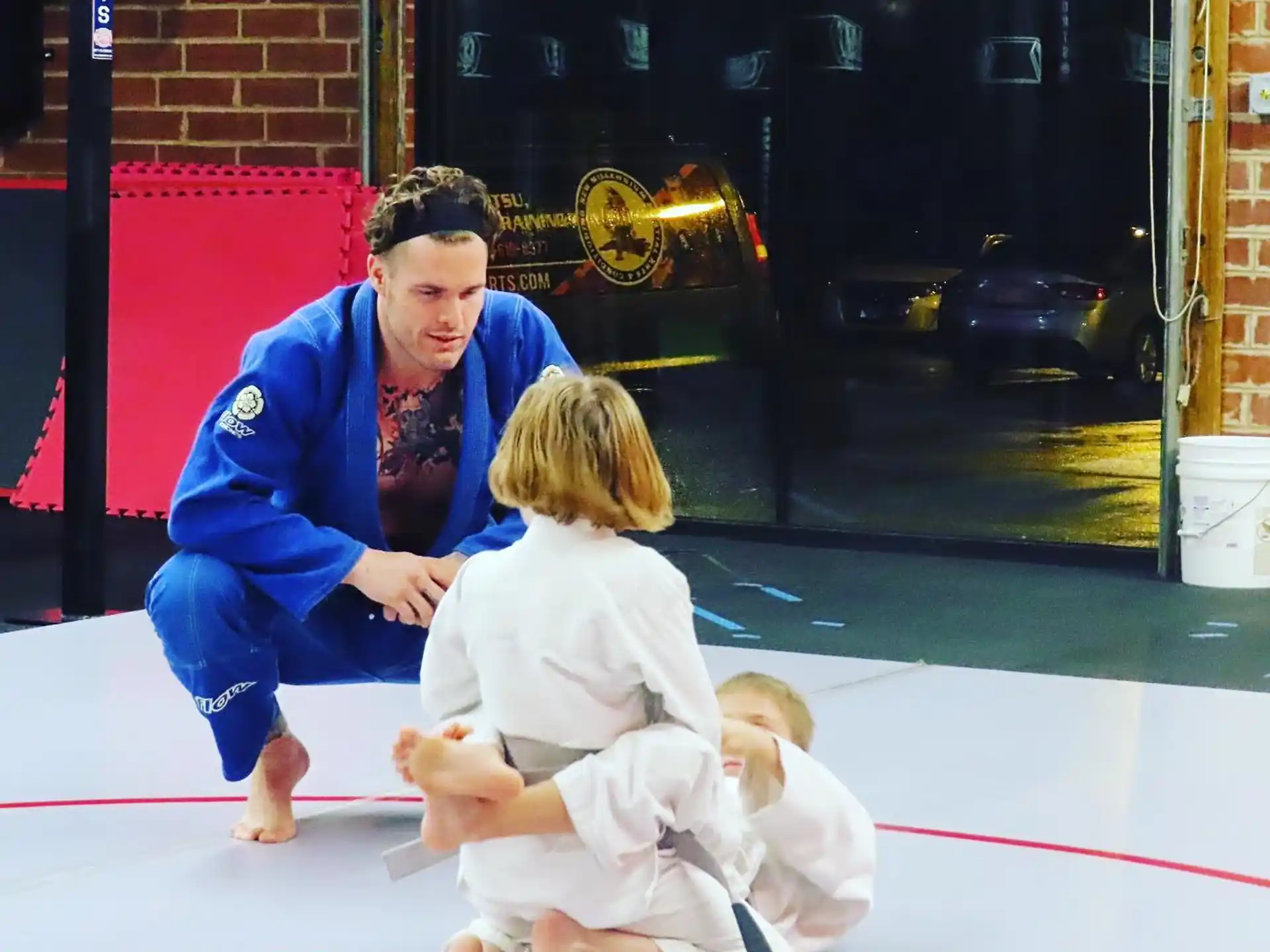 a person kneeling down to touch a baby on the ground