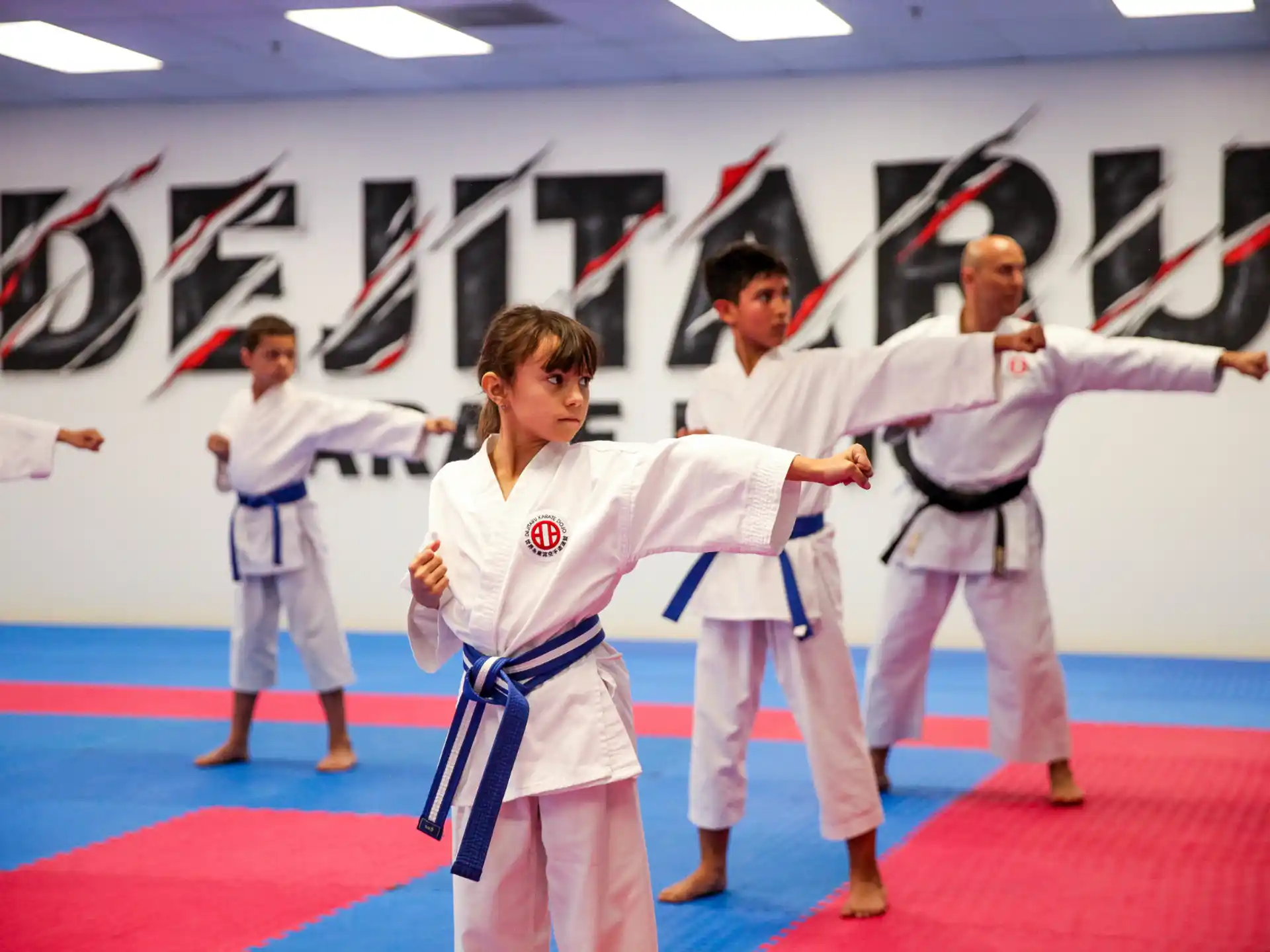 a group of people in karate uniforms