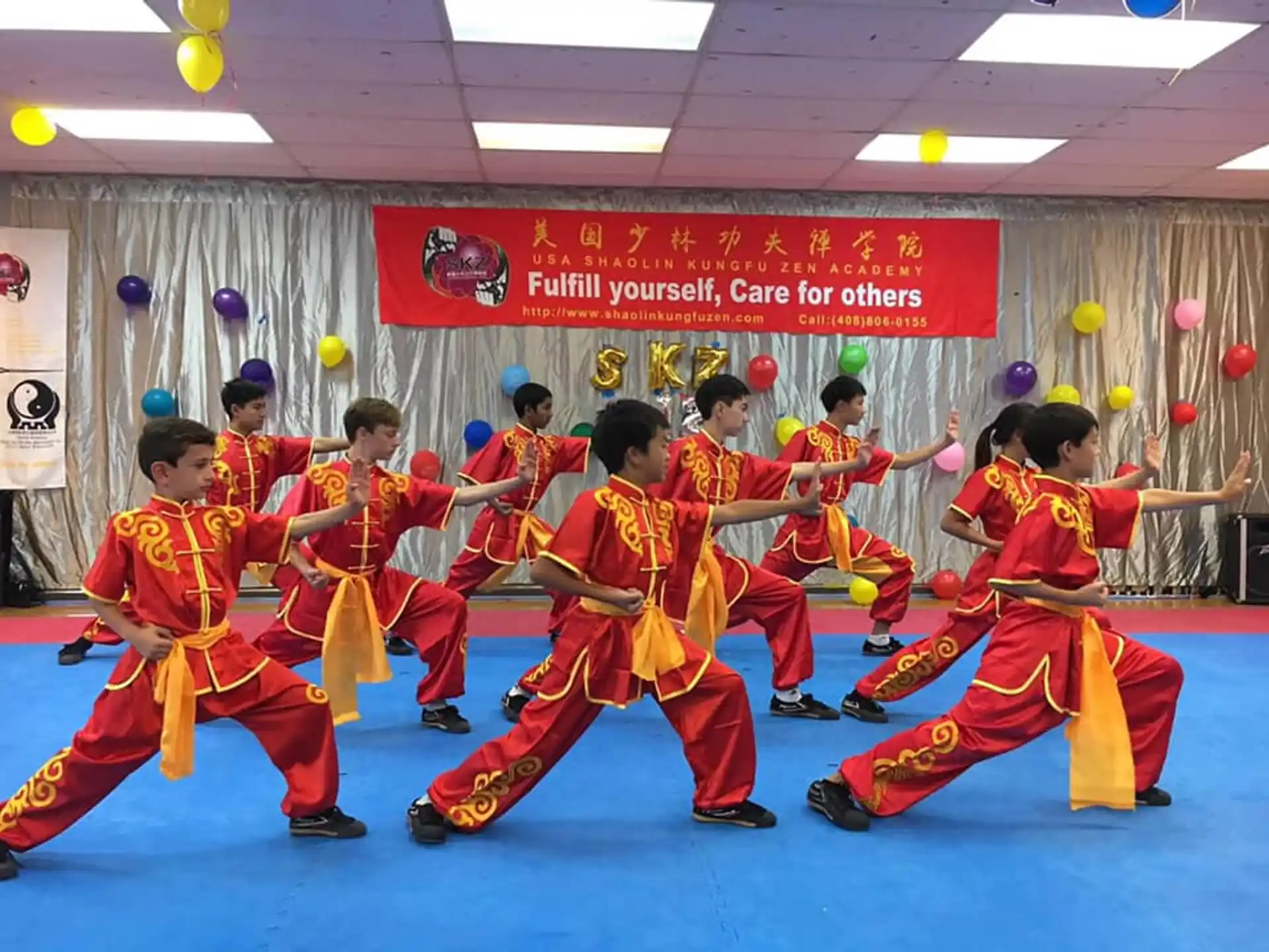 a group of people in red karate uniforms holding swords