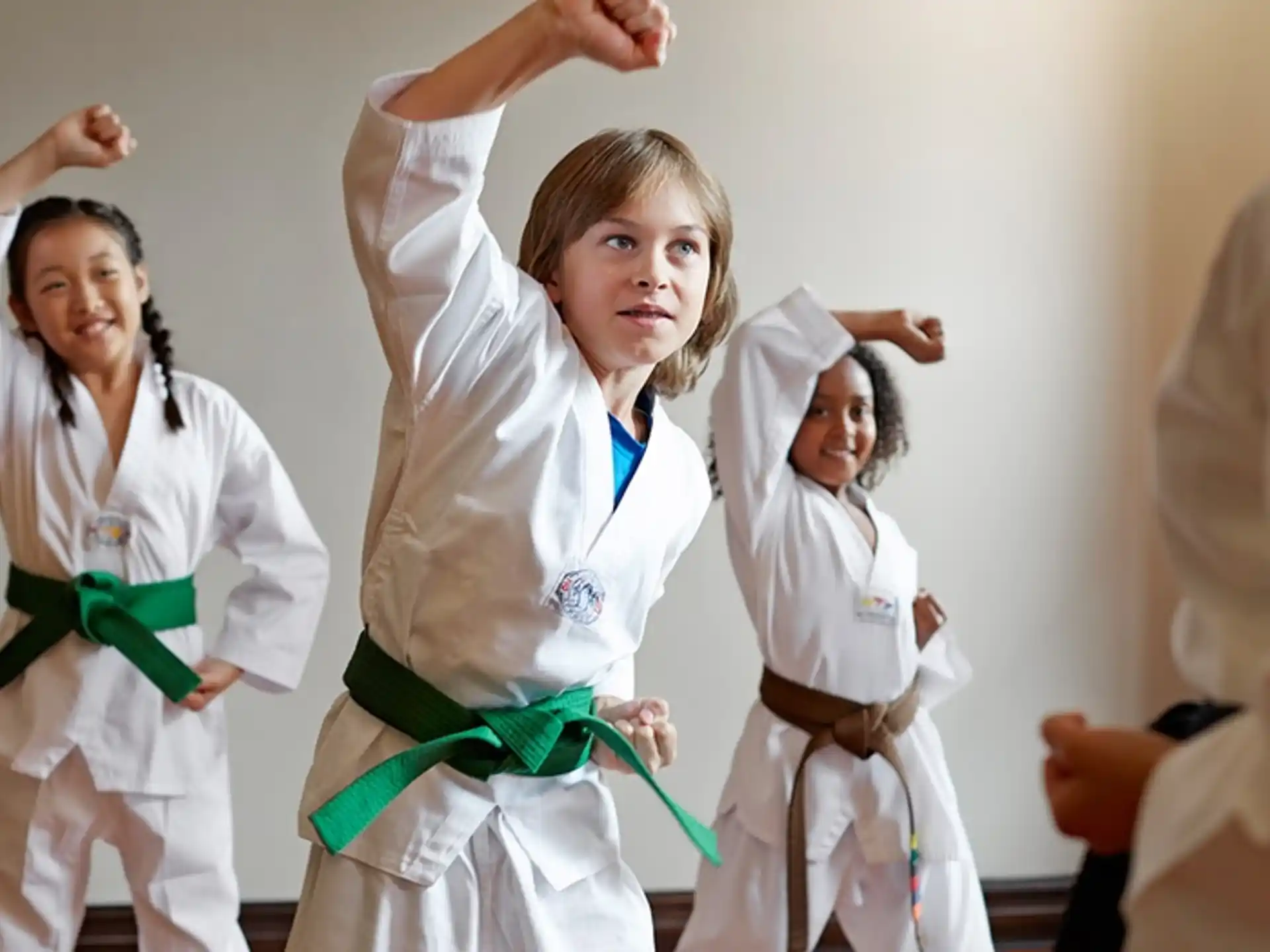 a group of women in white karate uniforms
