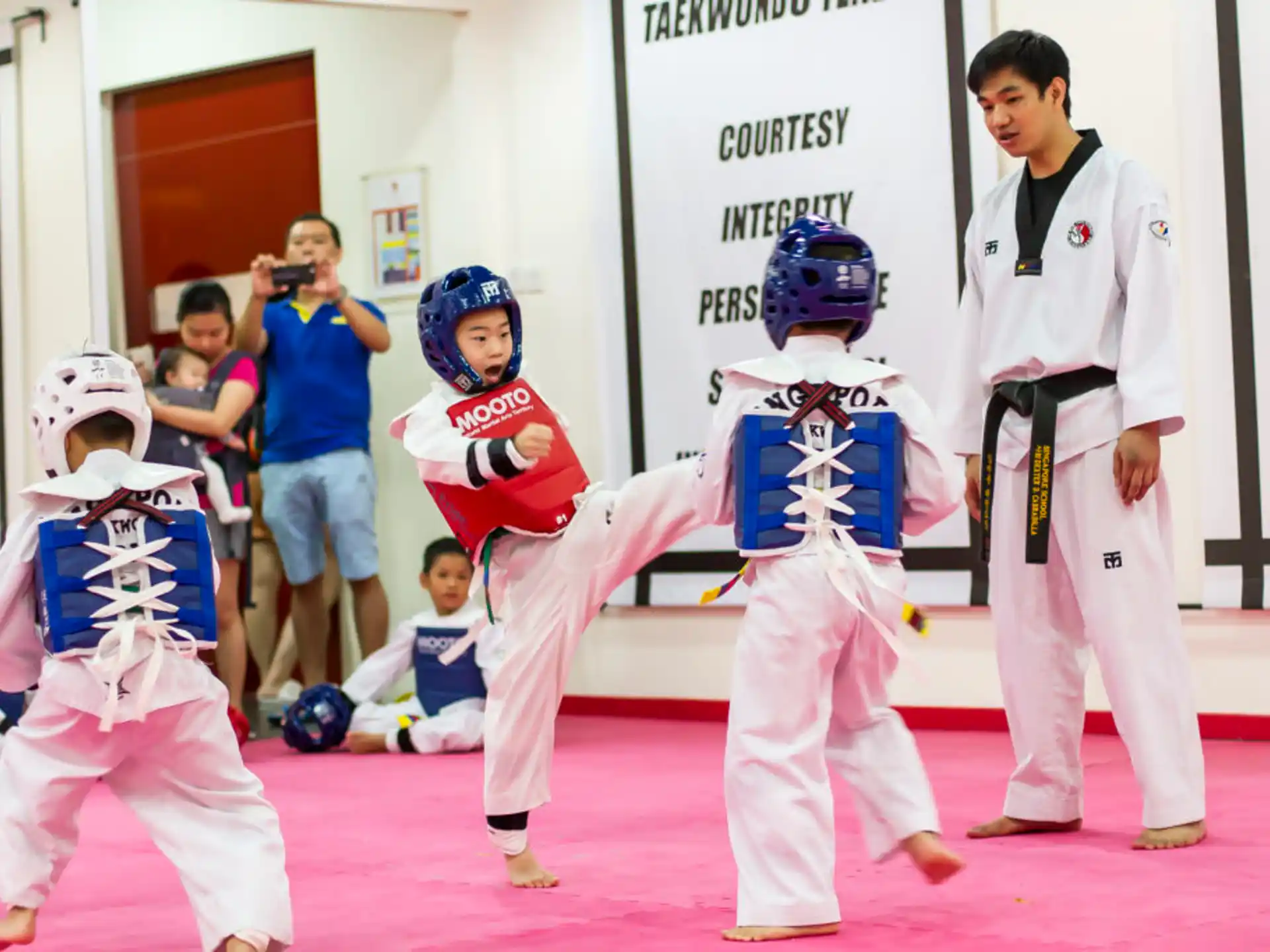 a group of people in white karate uniforms