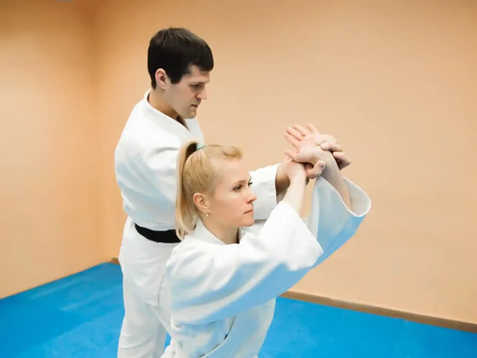 a man and a woman in karate uniforms