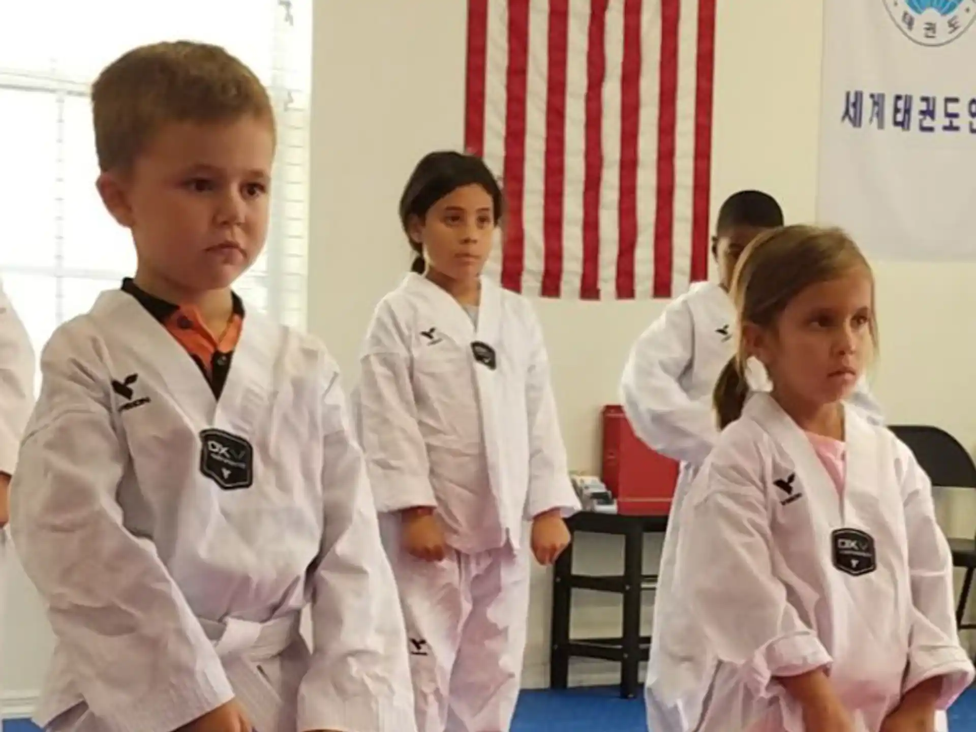 a group of children in karate uniforms