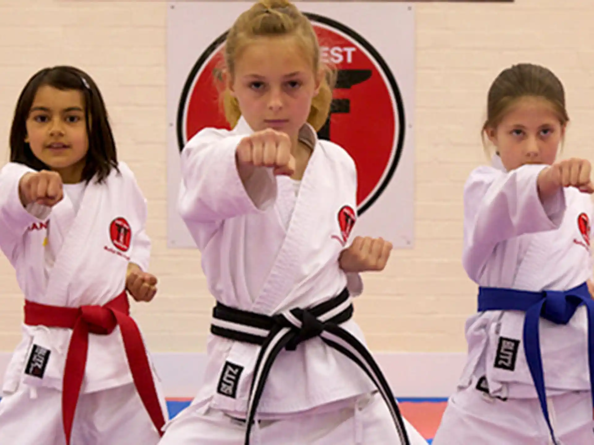 a group of girls in karate uniforms