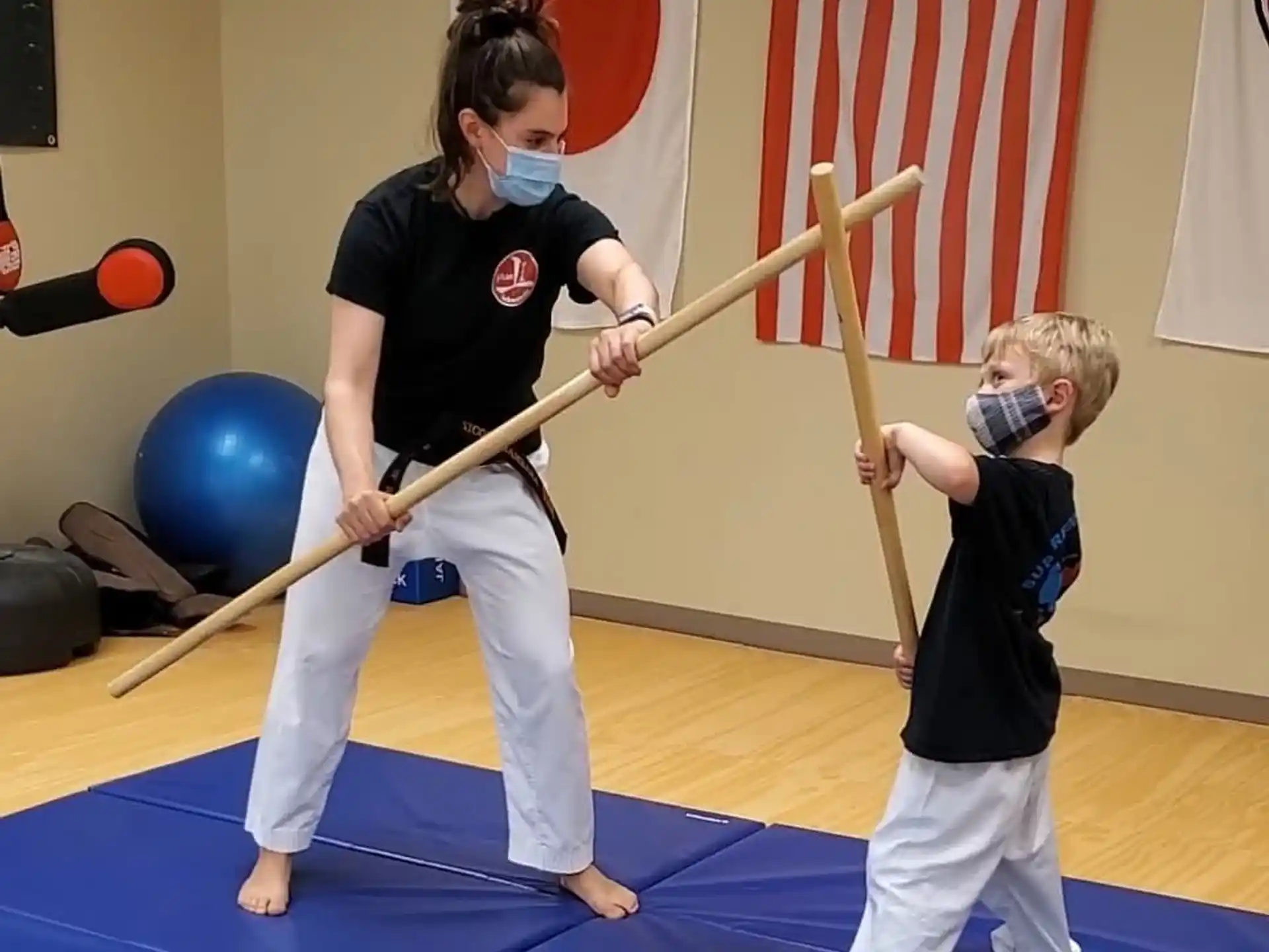 a person and a boy practicing martial arts