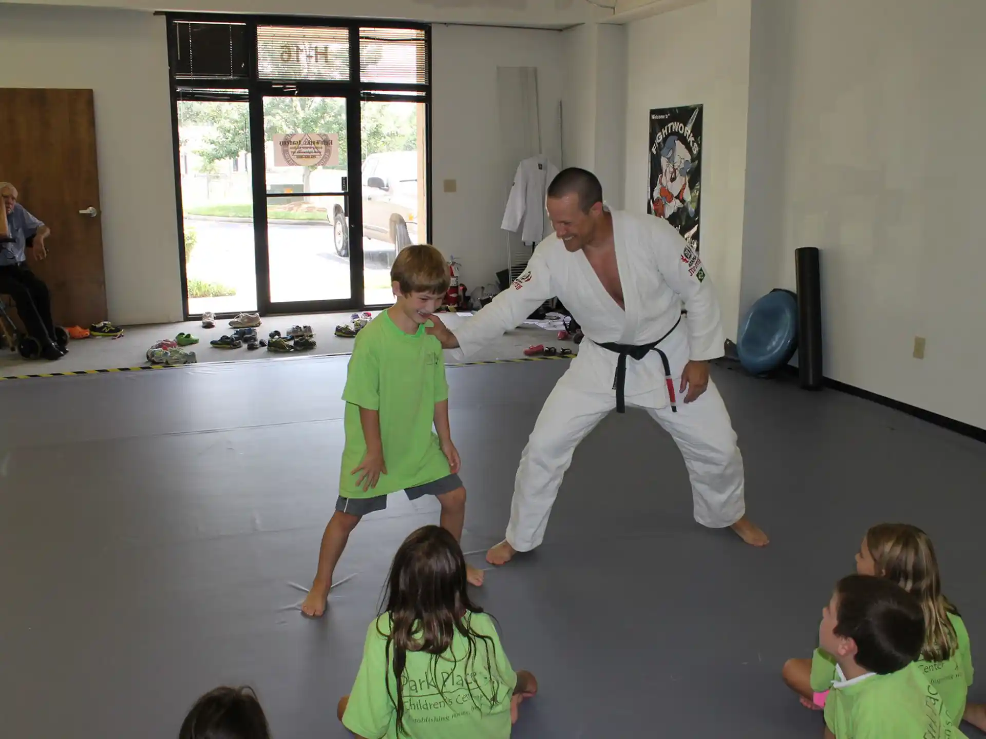 a person in a white suit and a group of children in a room