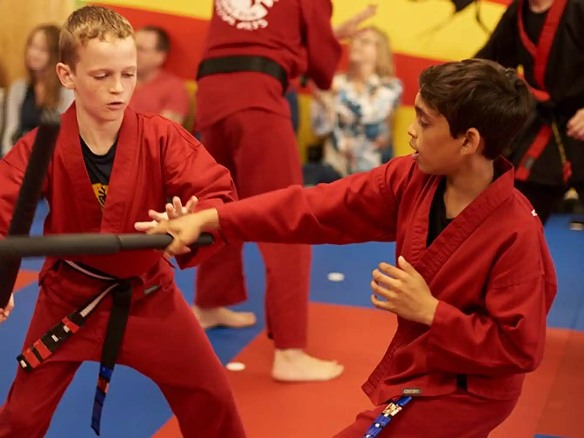 a group of people in red karate uniforms