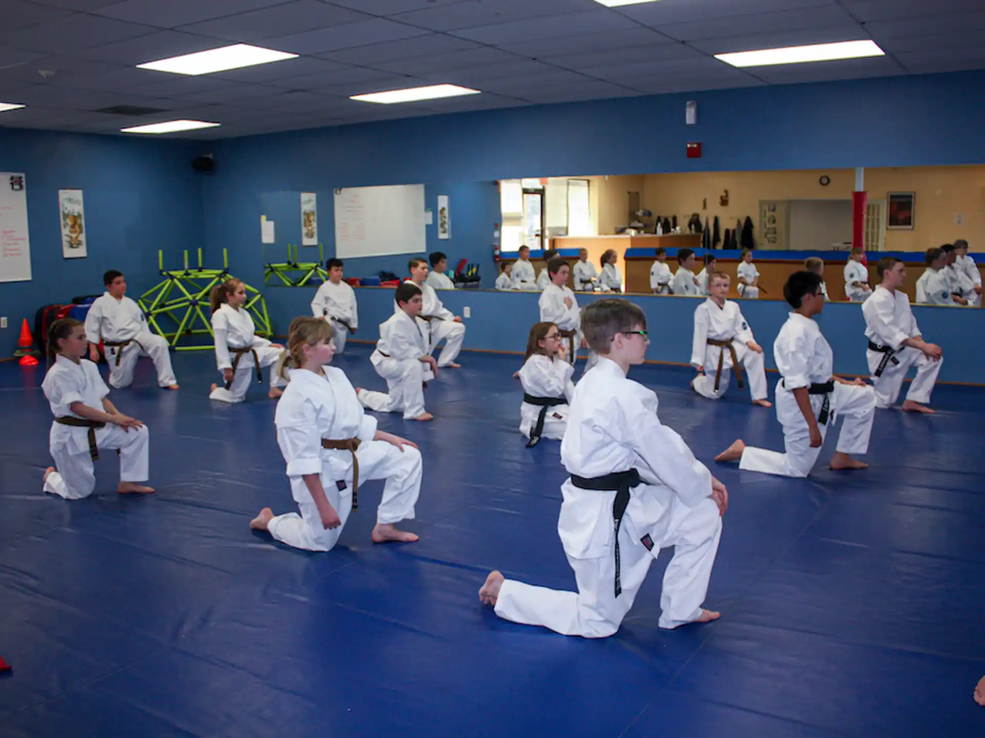 a group of children in karate uniforms