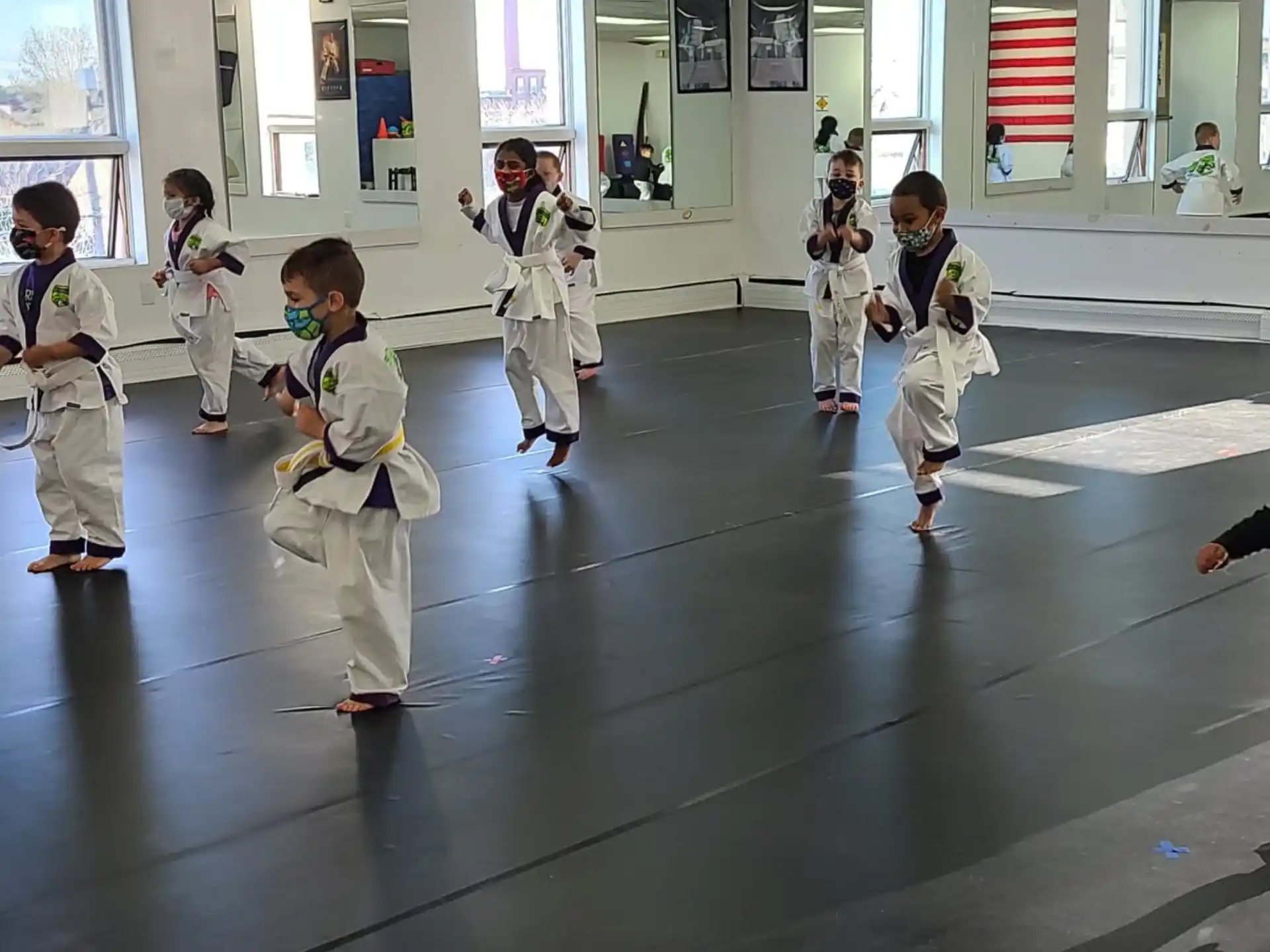 a group of children in karate uniforms