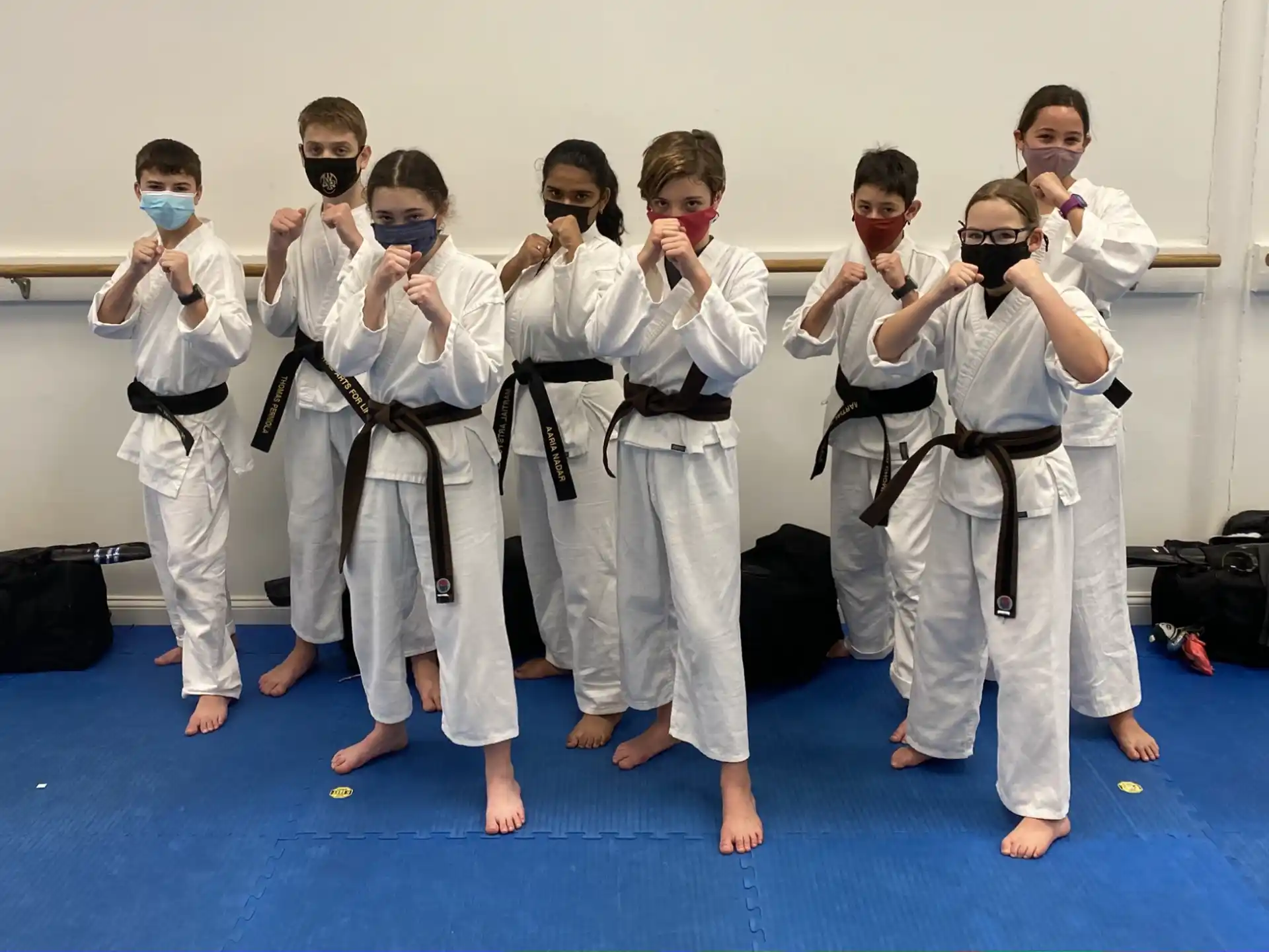 a group of people wearing white karate uniforms