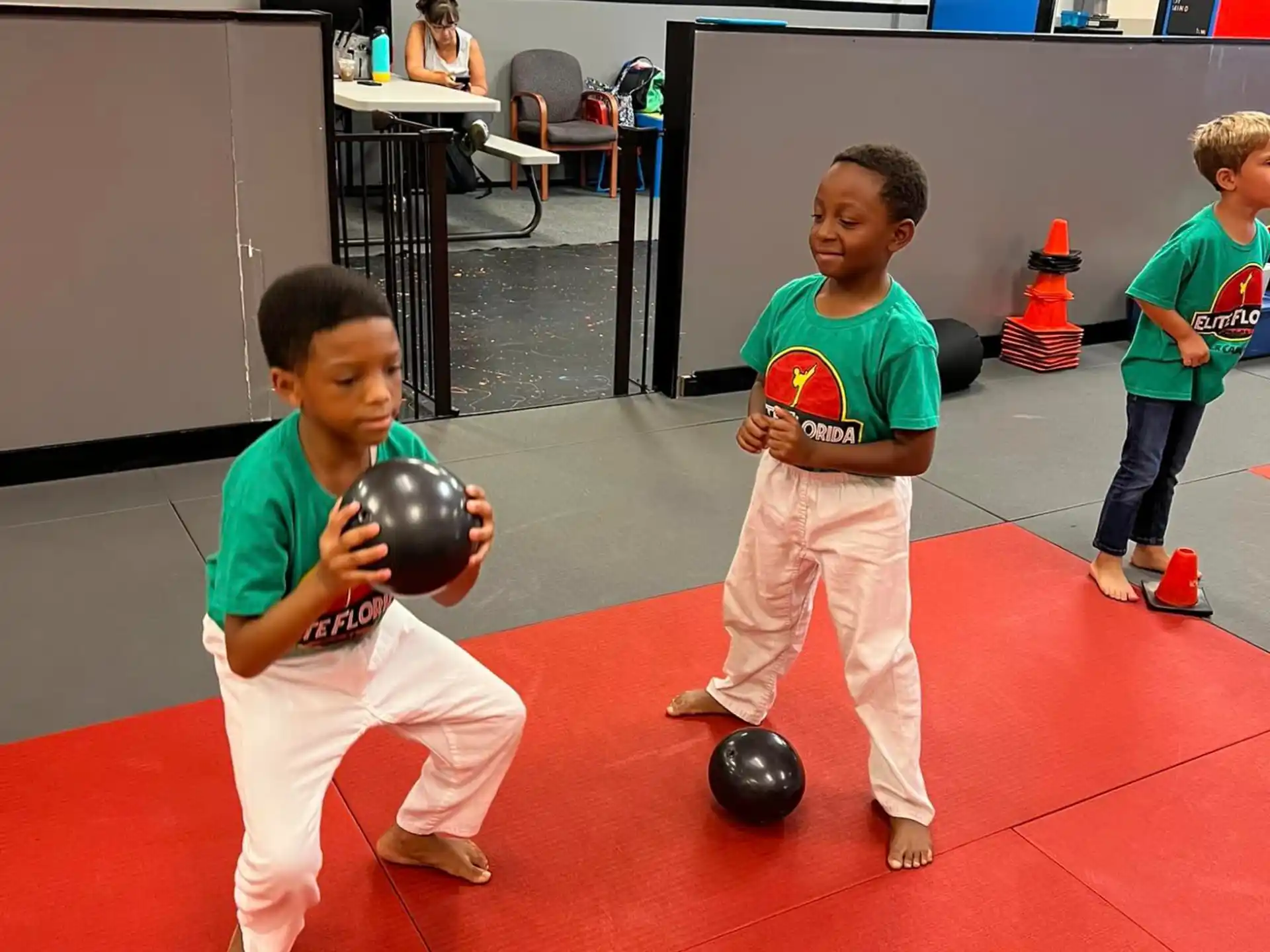 a group of kids playing with balls