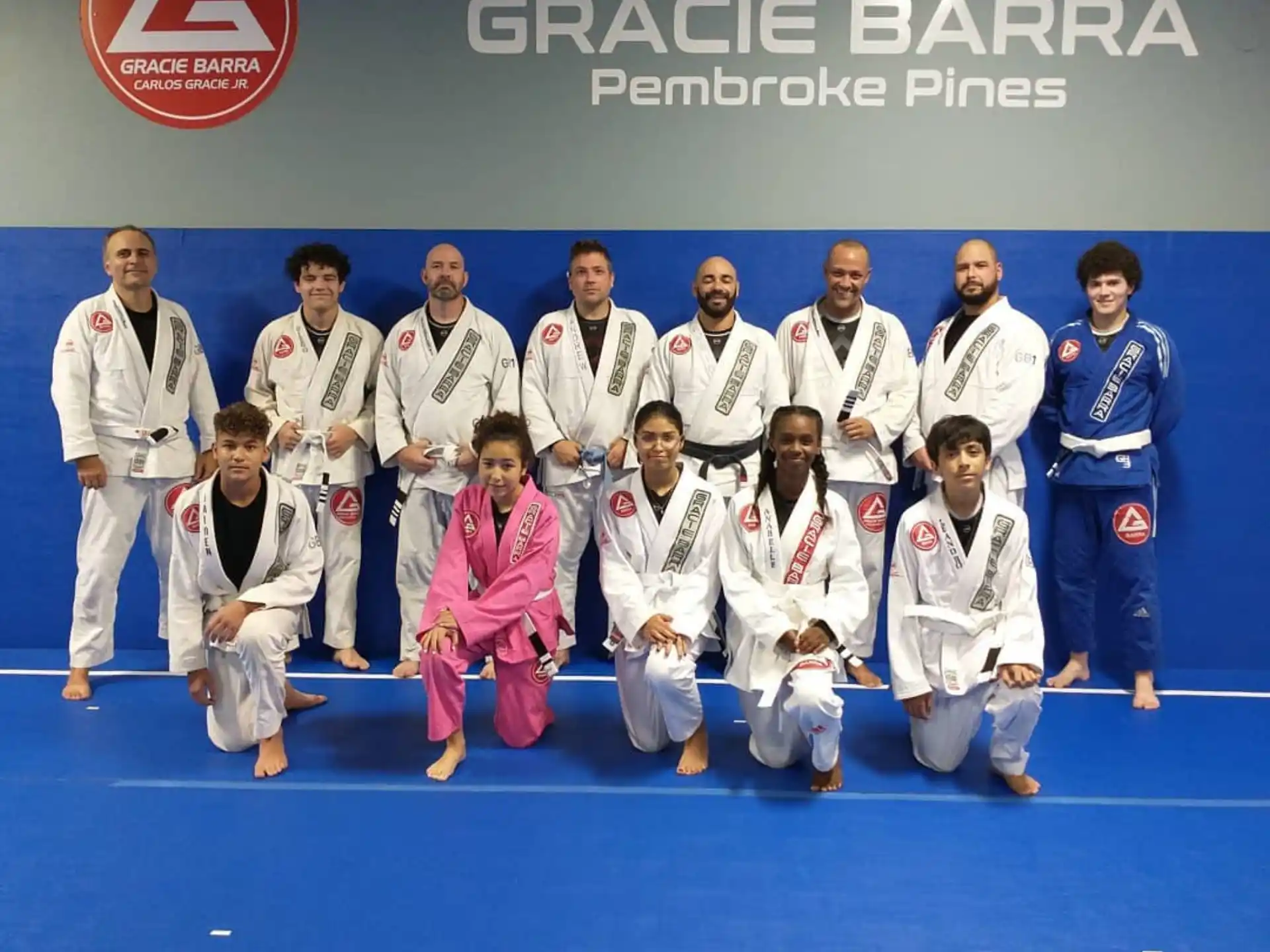 a group of people in white karate uniforms posing for a photo