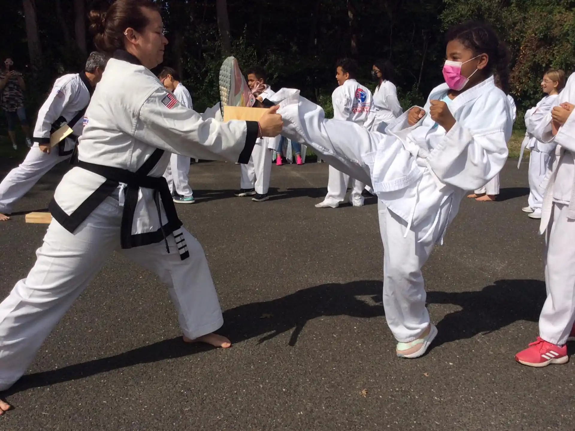 a group of people in white karate uniforms