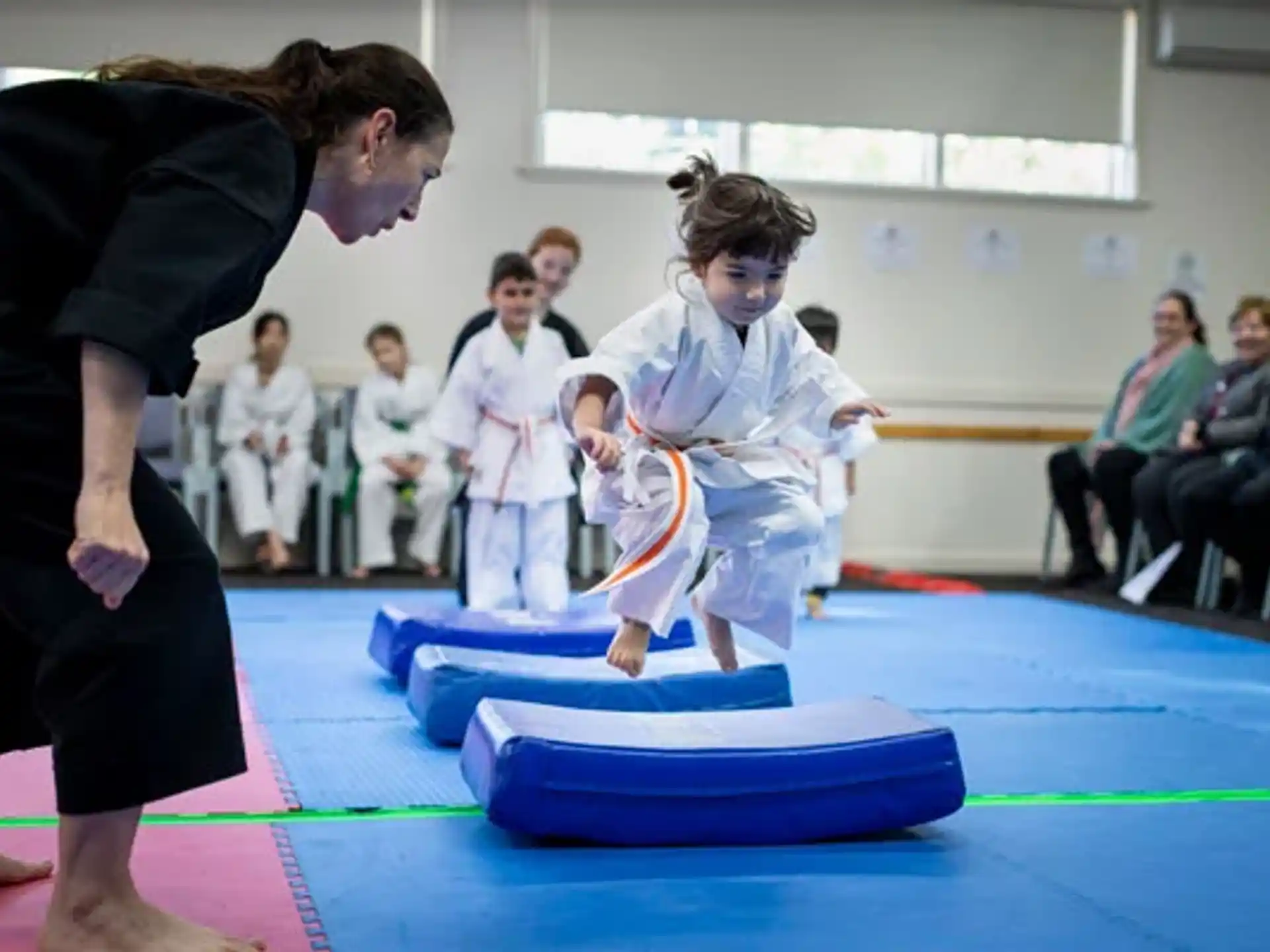 a person and a child practicing karate