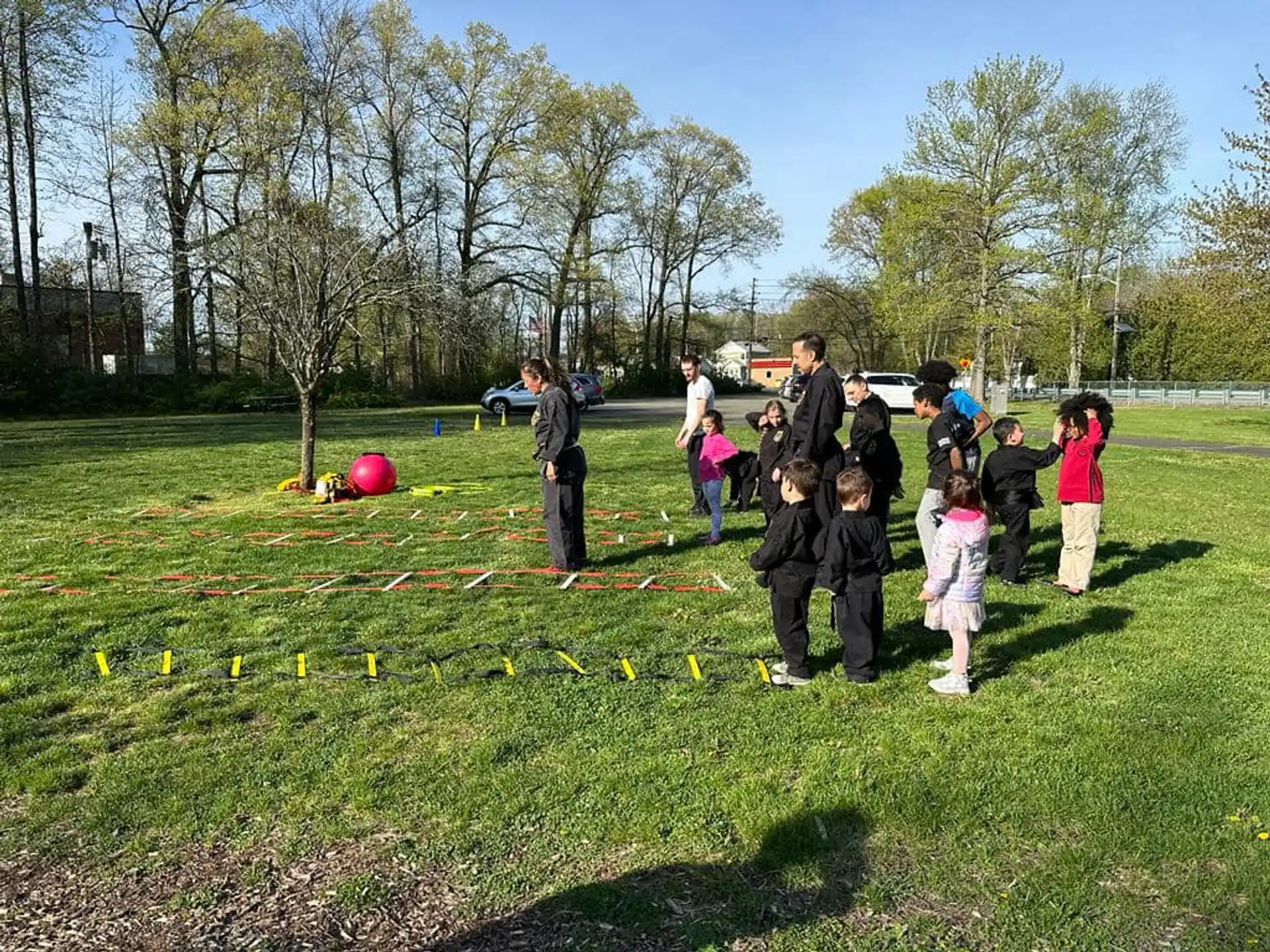 a group of people playing with a ball in a grassy field
