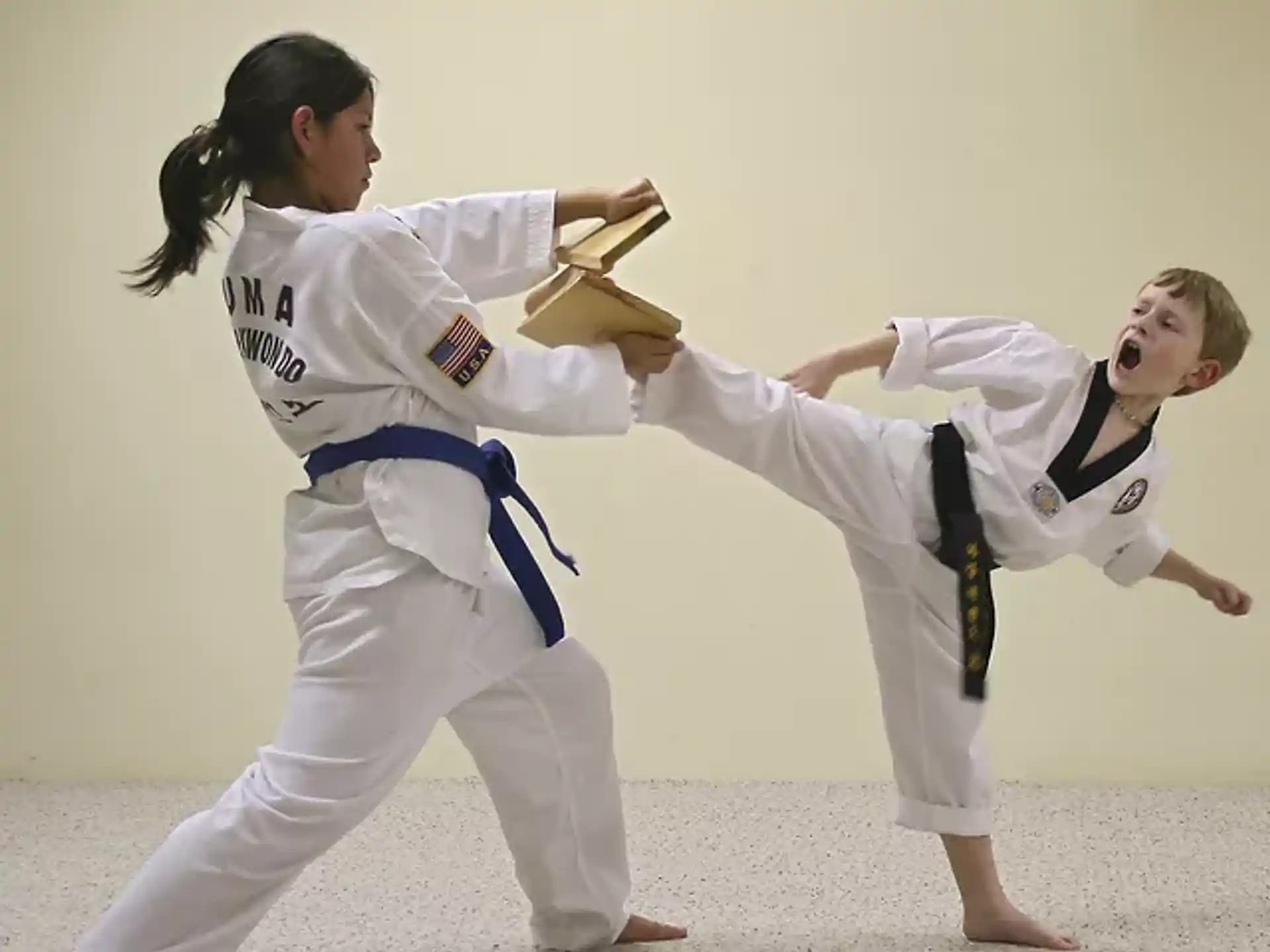 a man and woman in karate uniforms