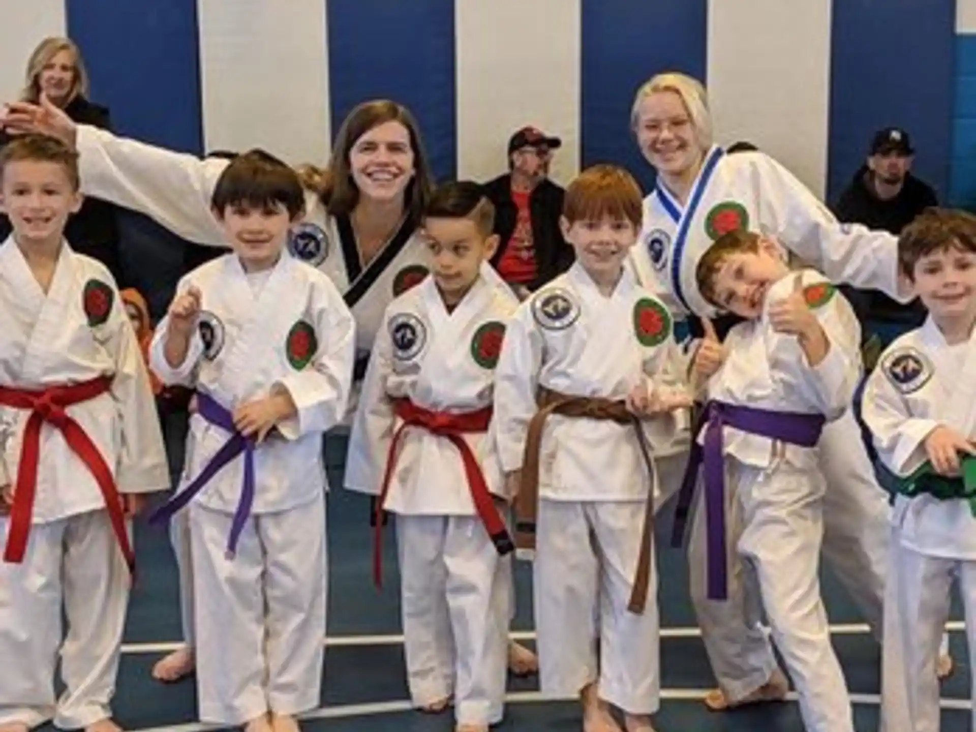 a group of children in karate uniforms