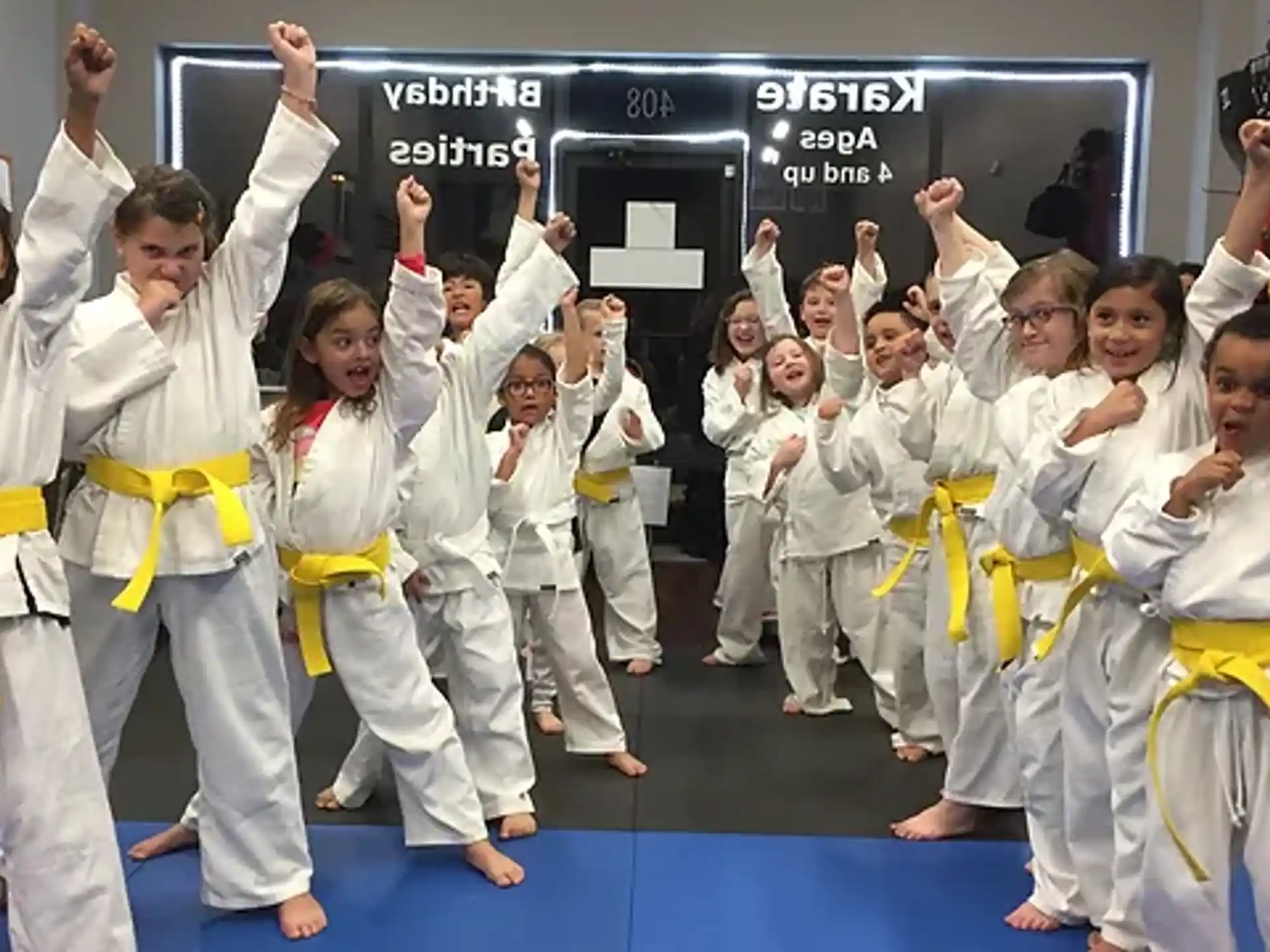 a group of children in karate uniforms