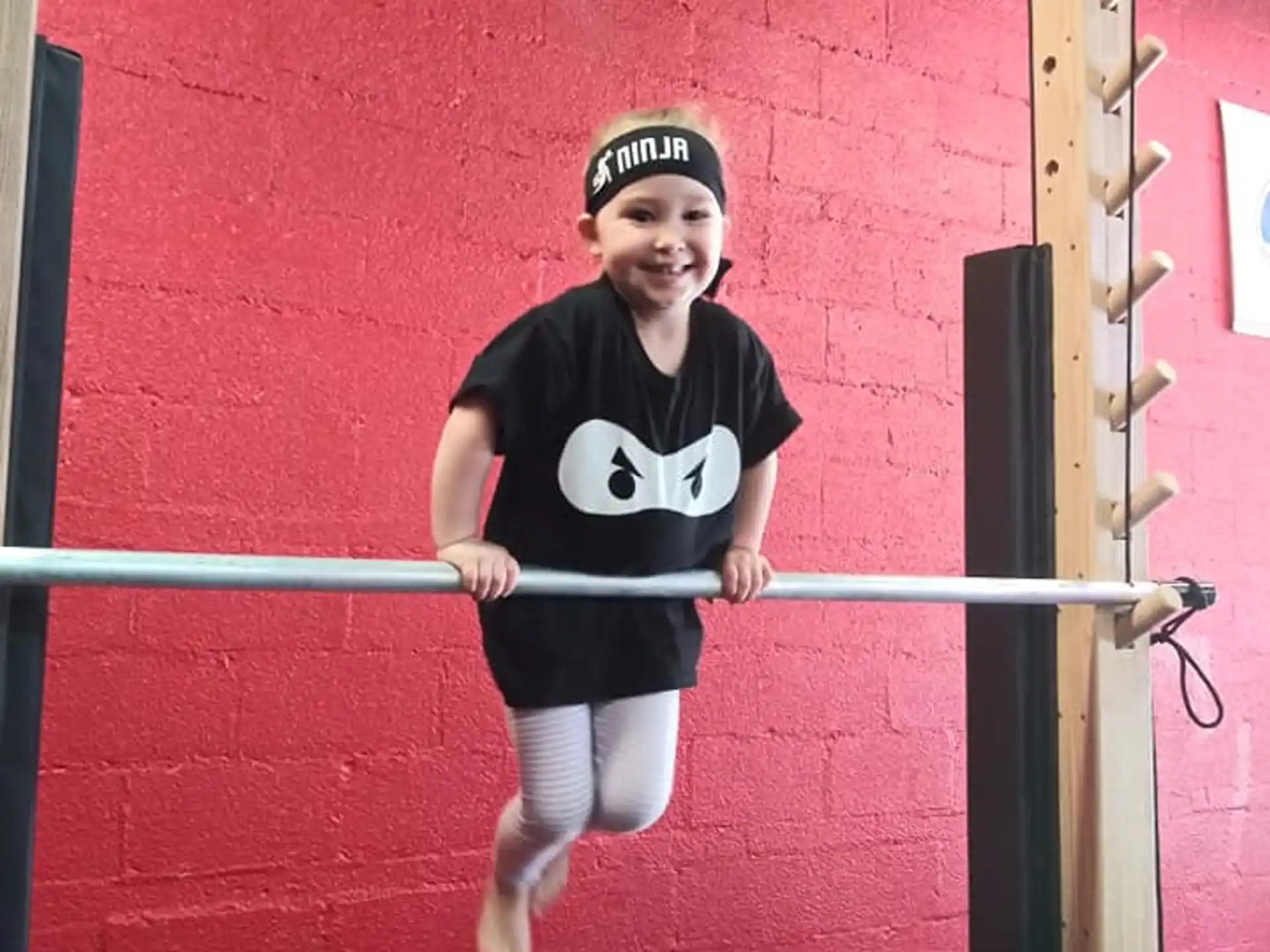 a boy jumping on a bar