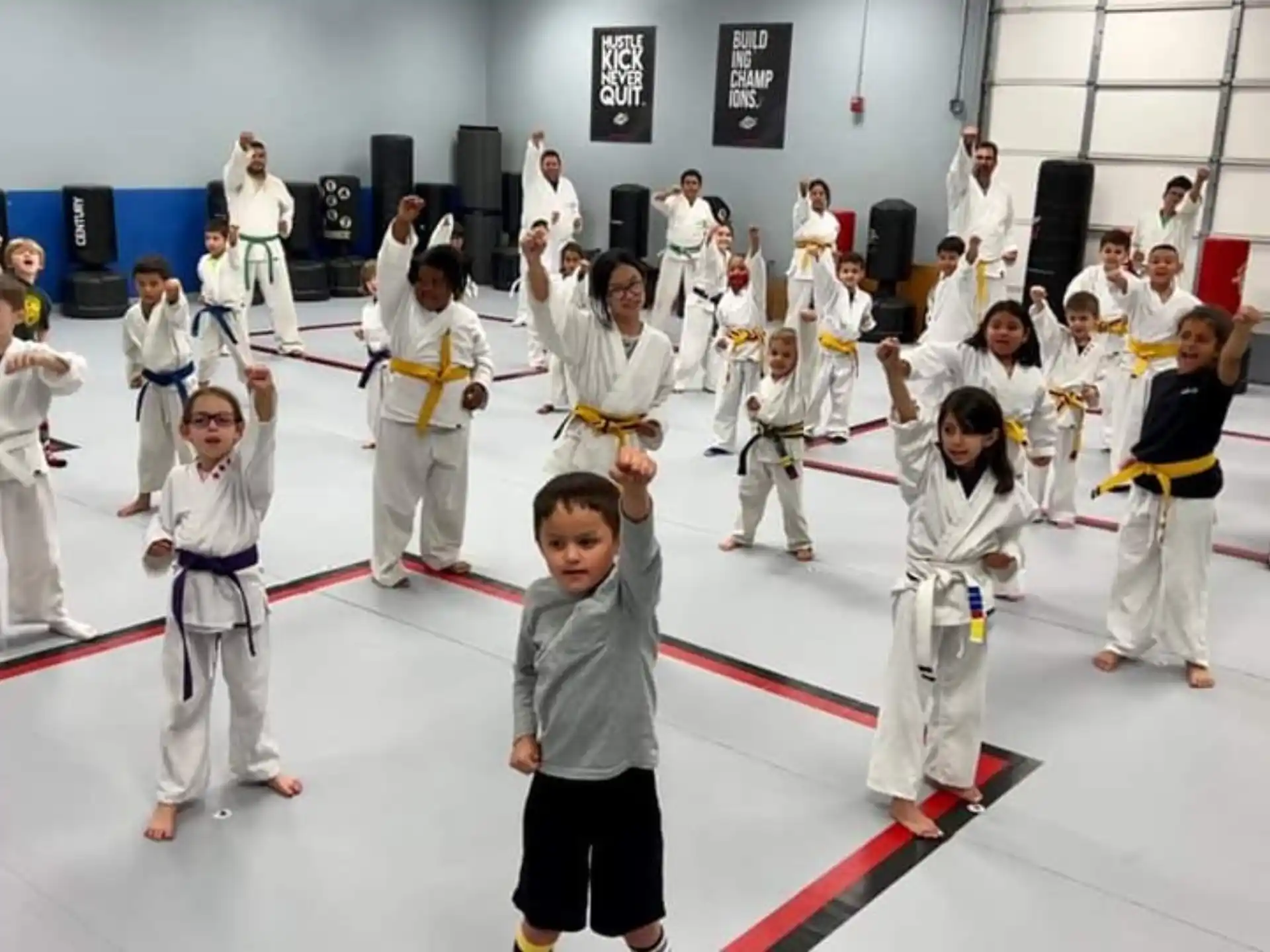 a group of children in karate uniforms