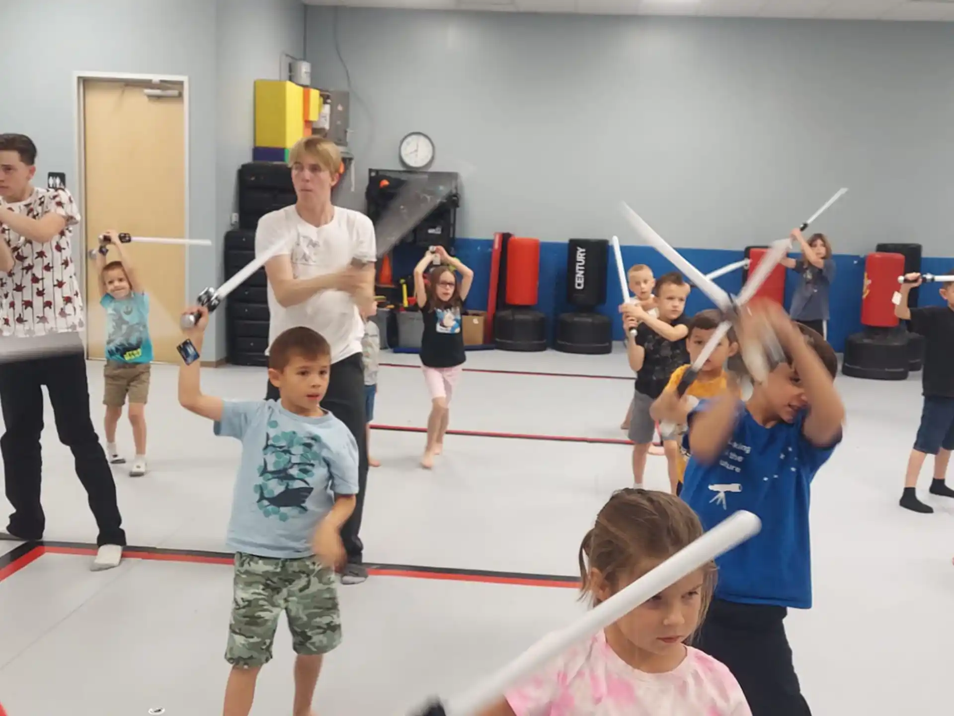a group of children playing with a toy sword