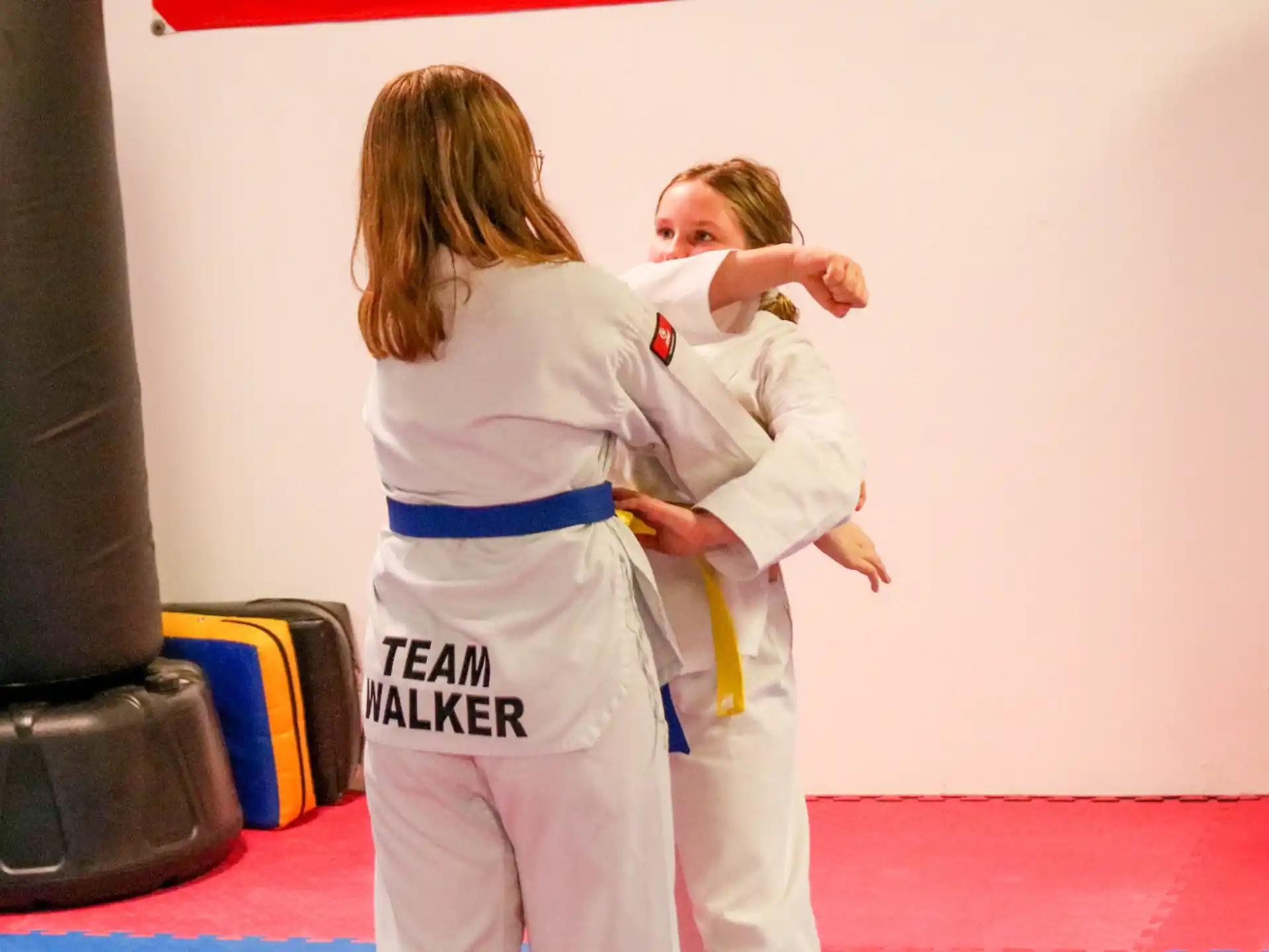 a person and a child in karate uniforms