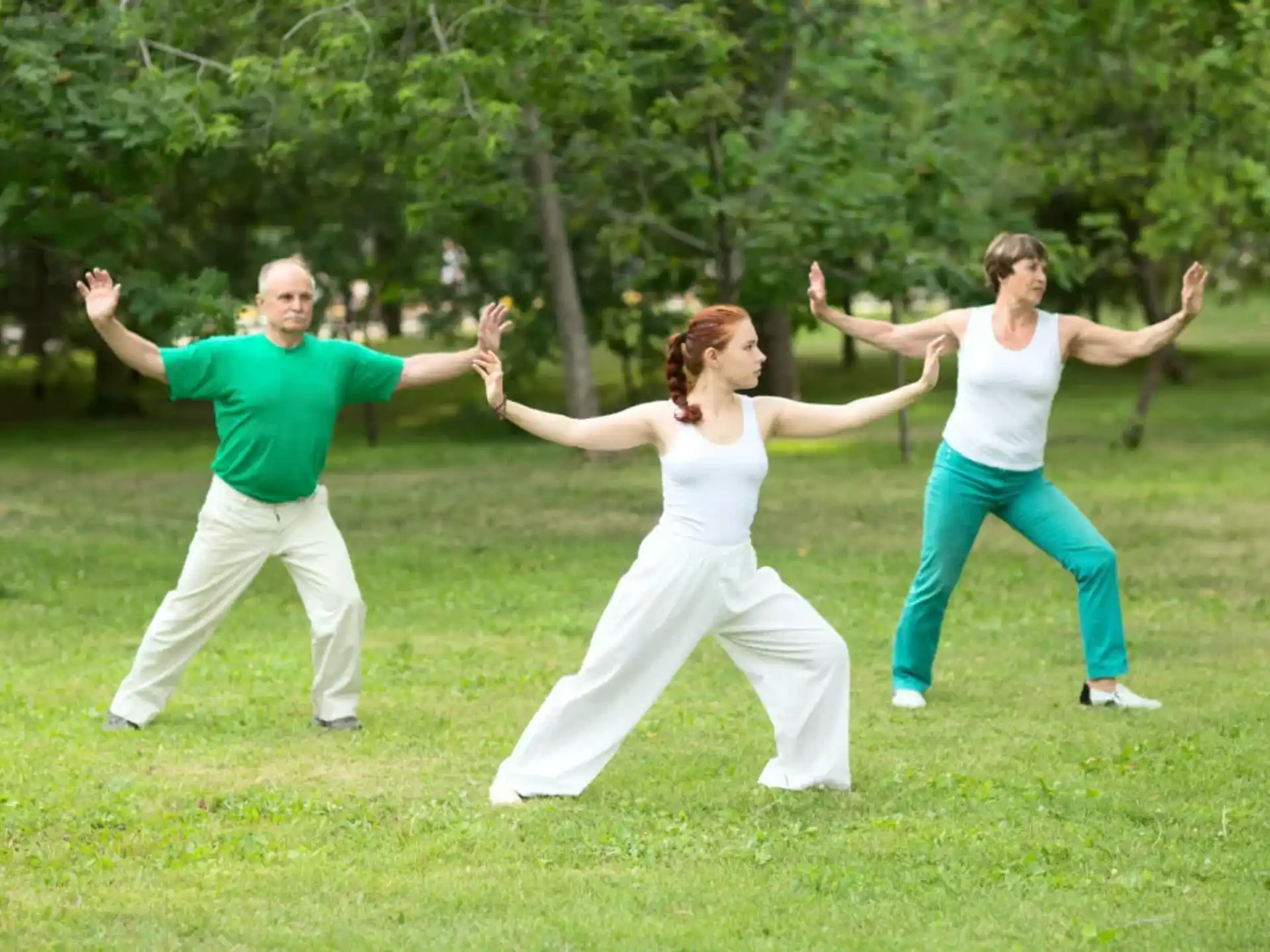 a group of people dancing in a park