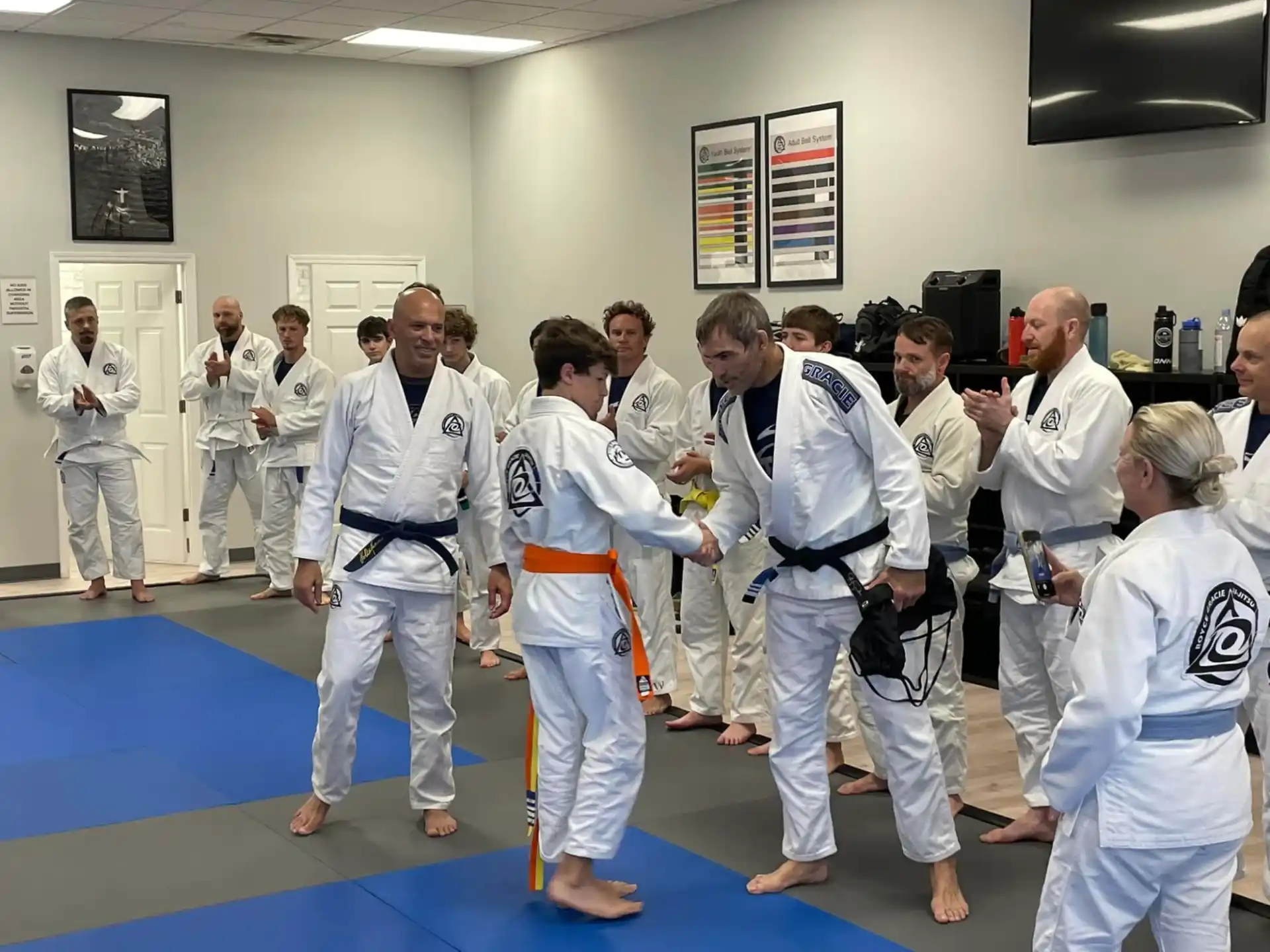 a group of people in white karate uniforms