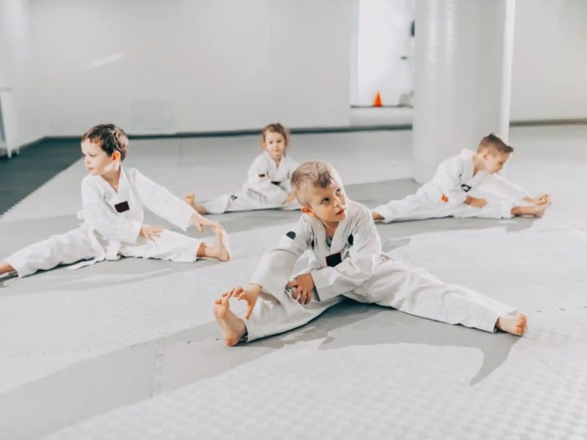 a group of people in white karate uniforms