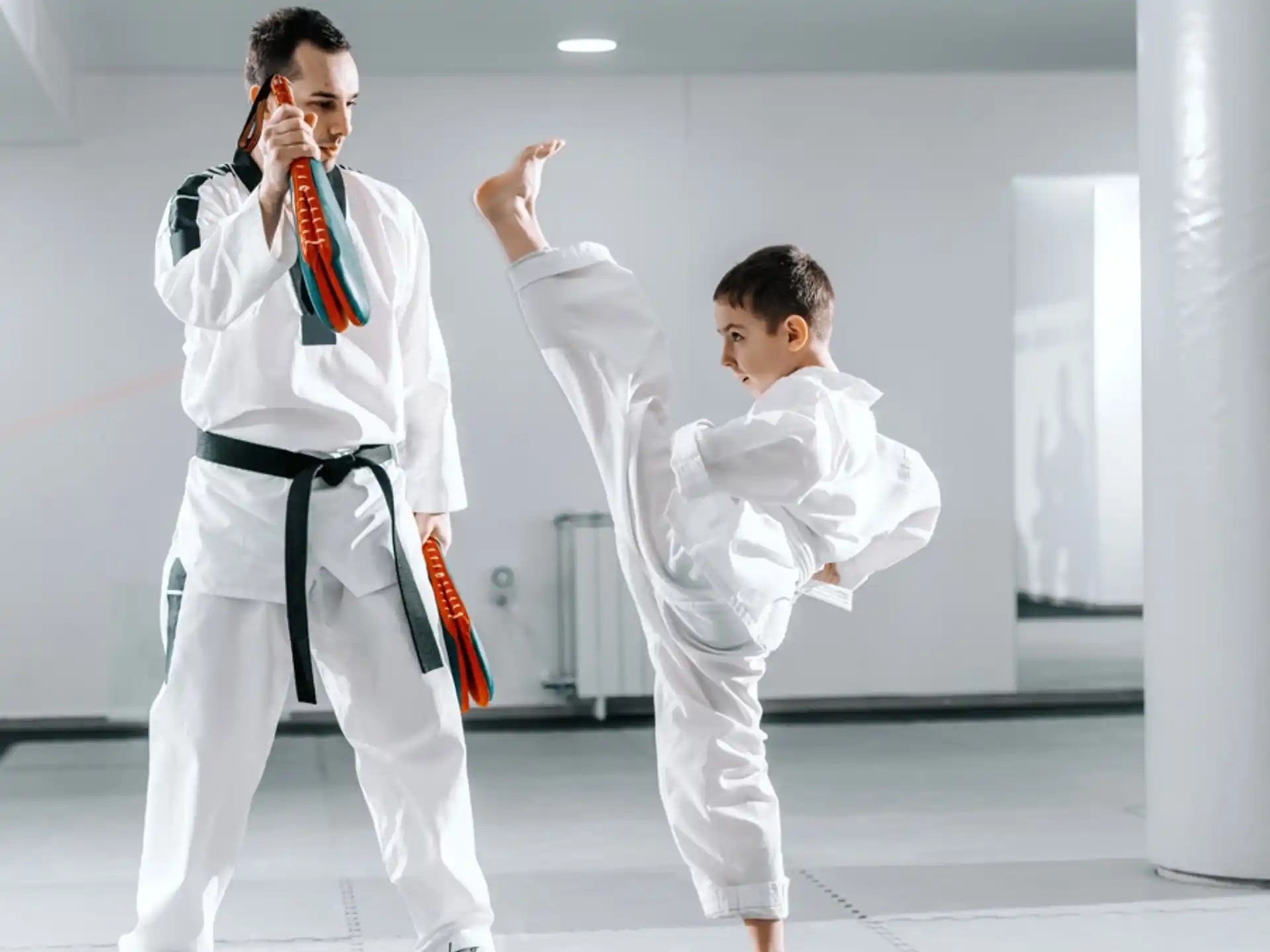 a man and a boy in karate uniforms