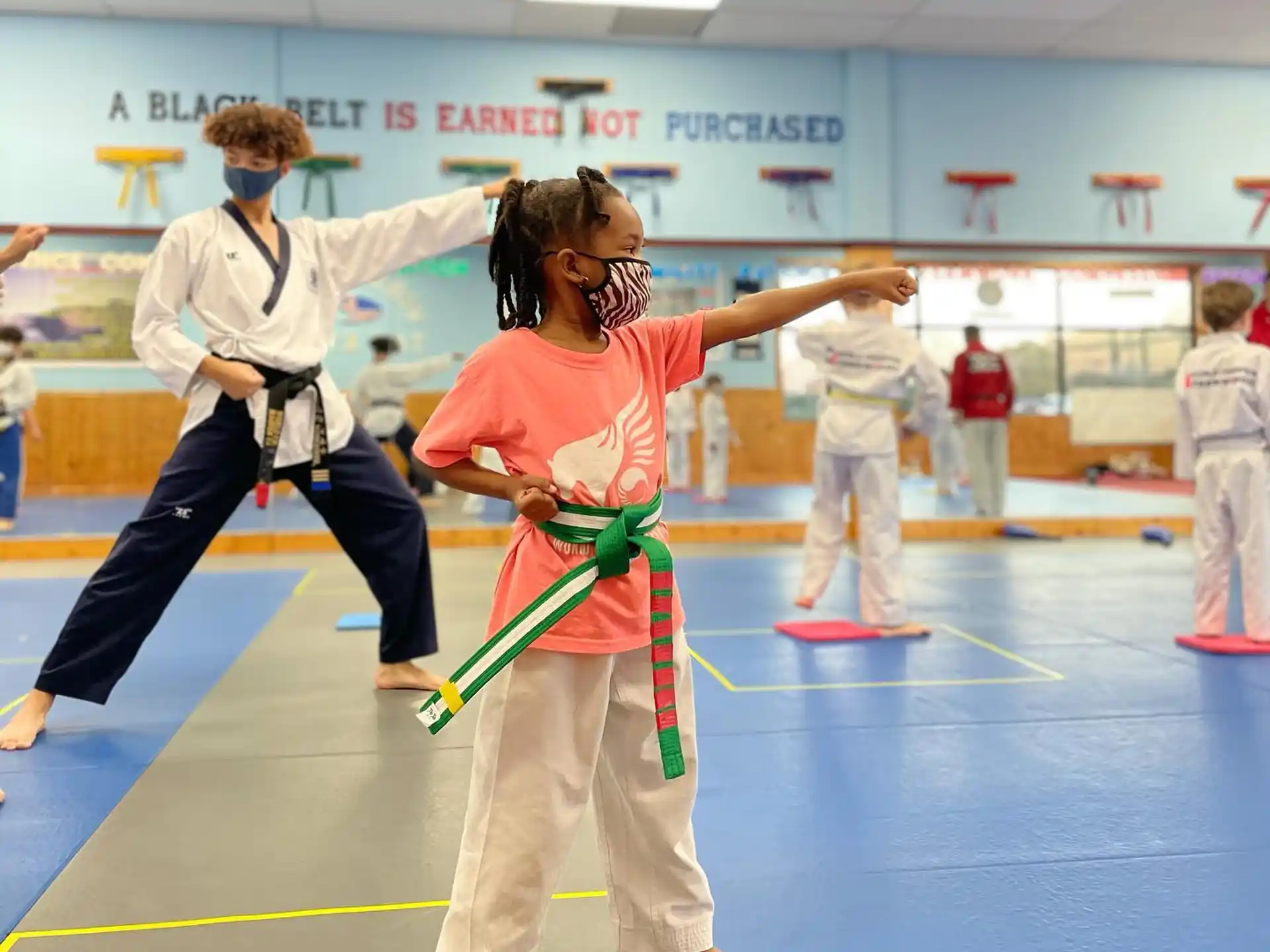 a group of people in a karate class