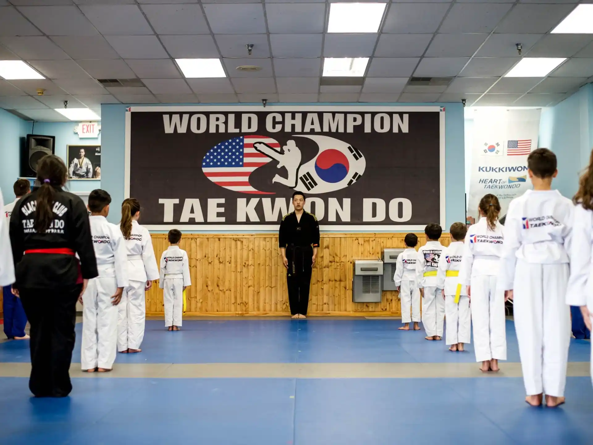 a group of people in white karate uniforms