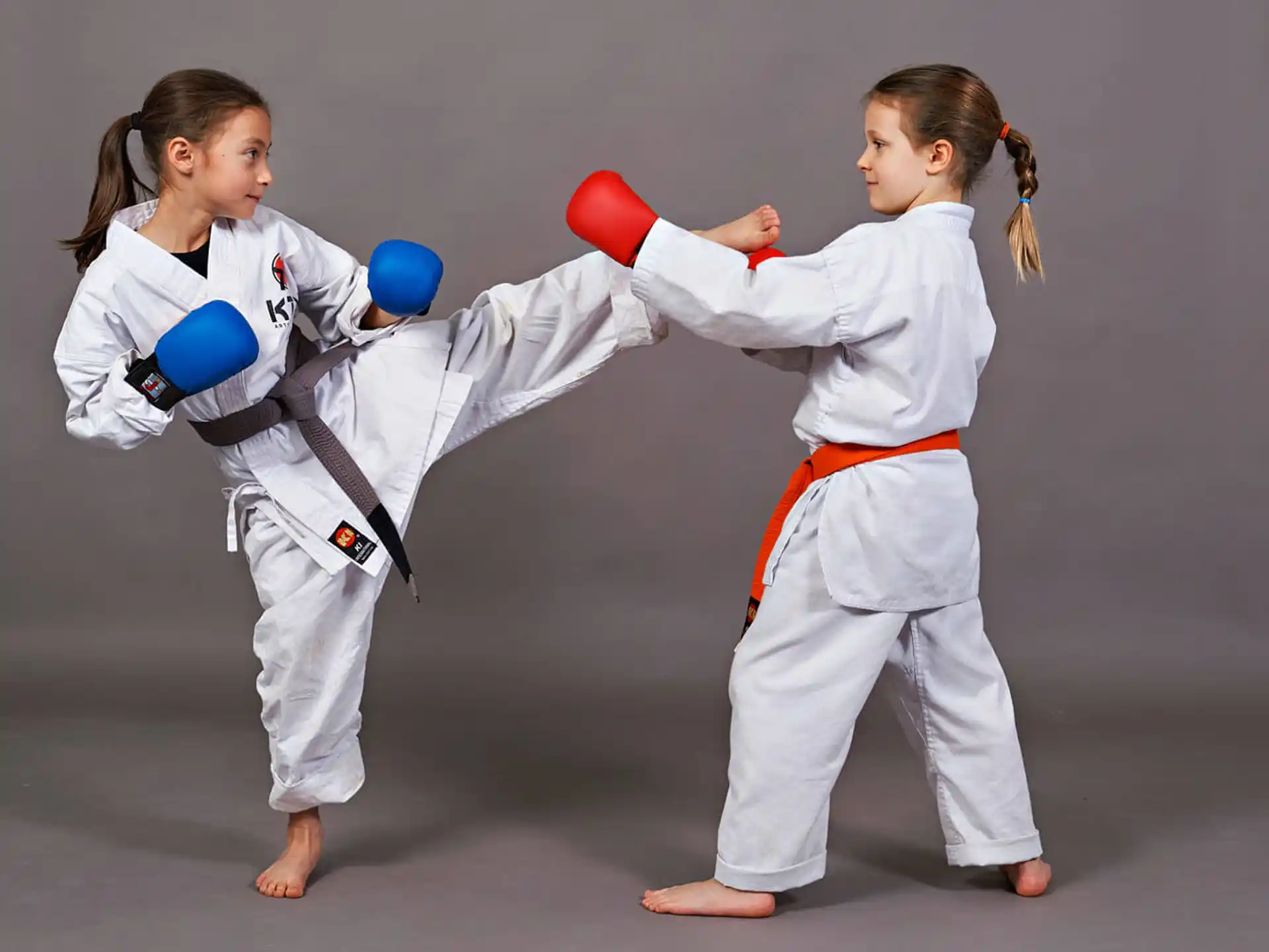 two girls in karate uniforms