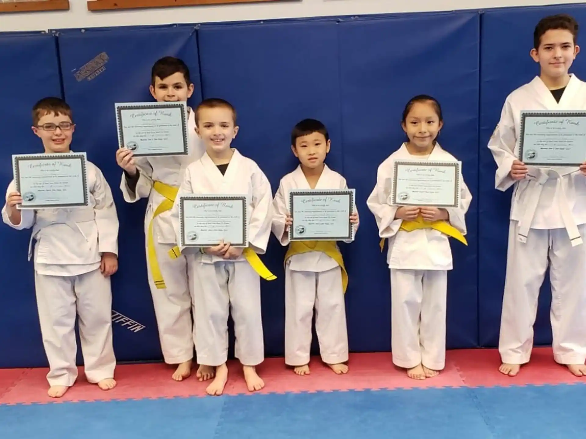 a group of children holding certificates
