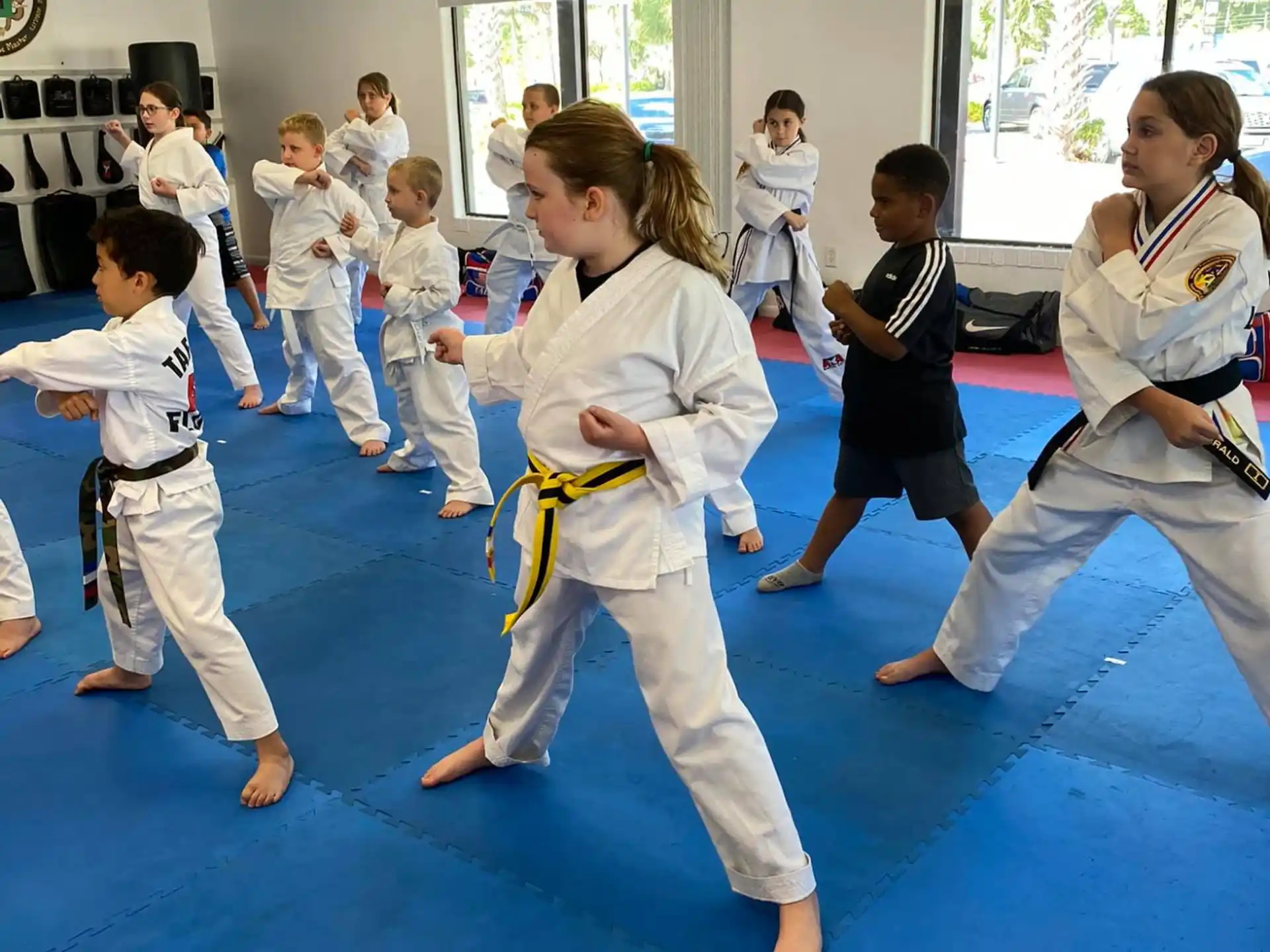 a group of children in karate uniforms