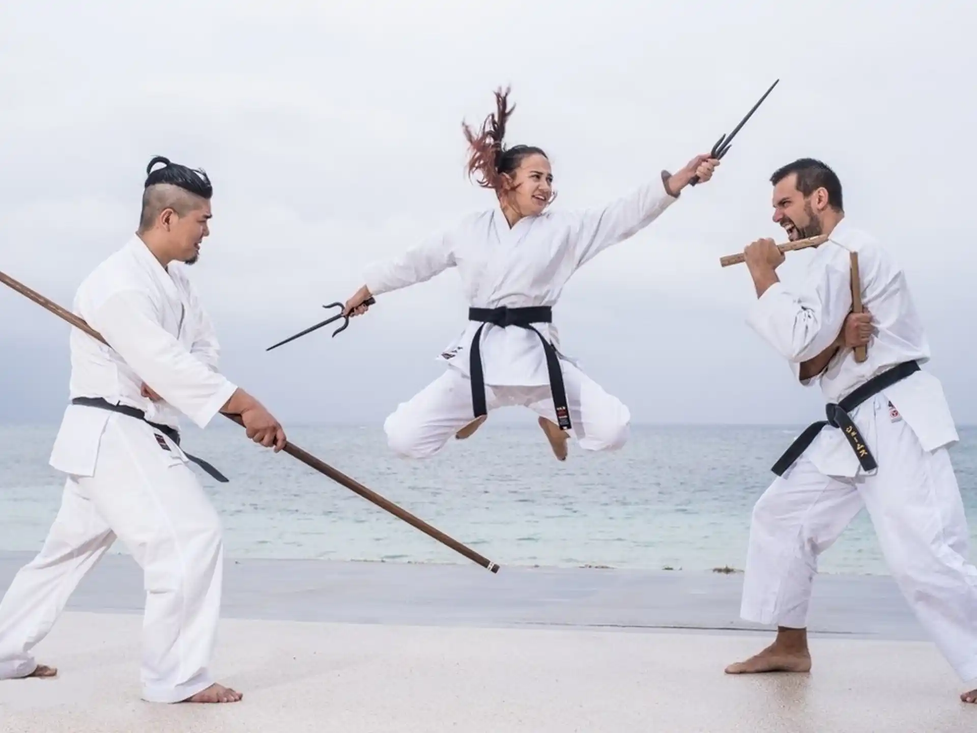 a group of people in white karate uniforms holding swords