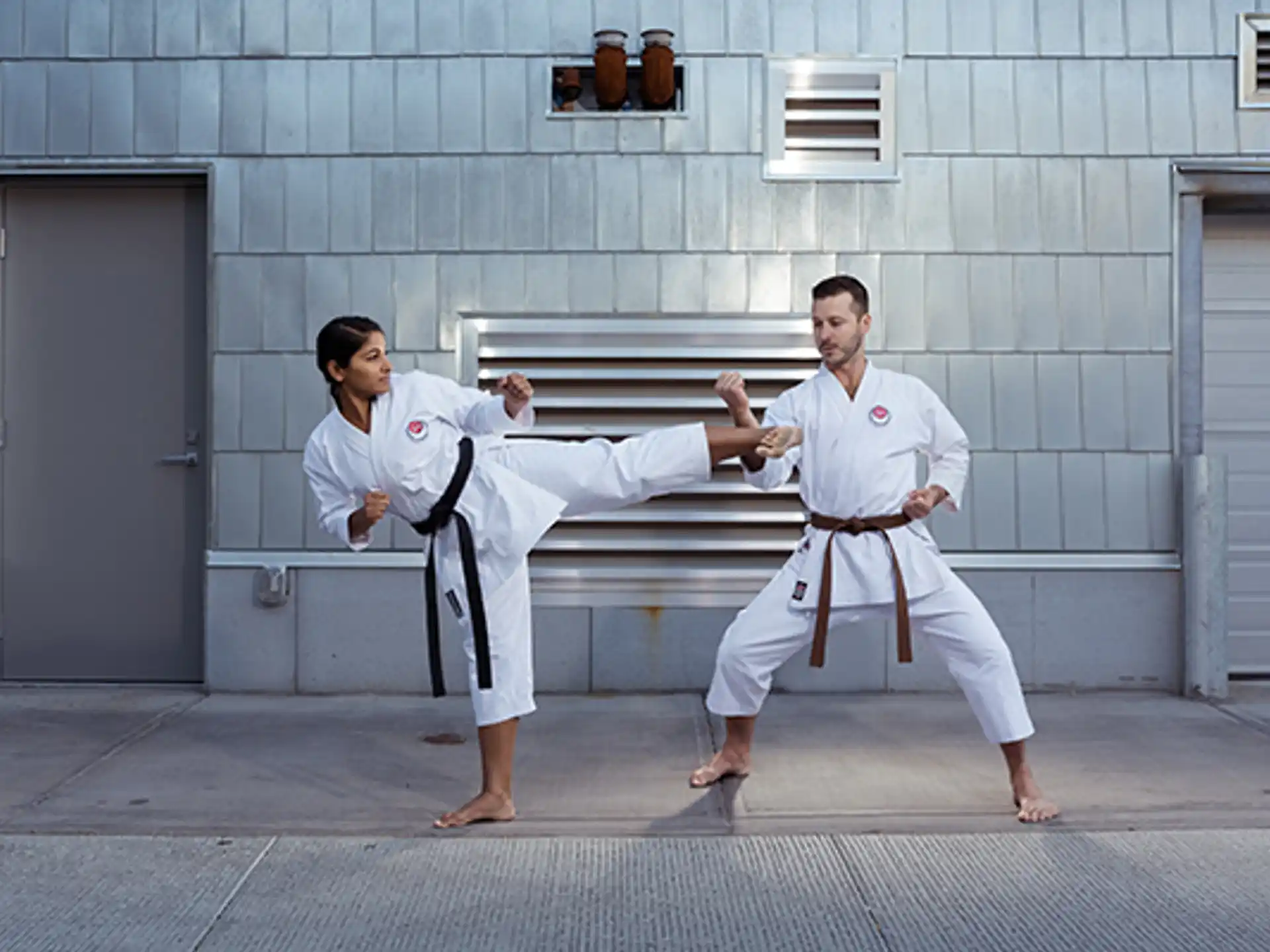 a man and woman in karate uniforms