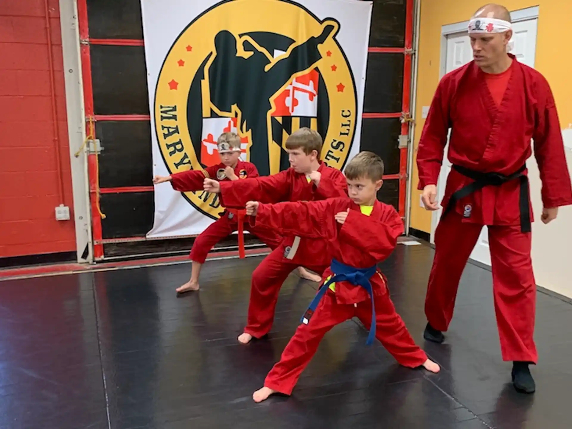 a group of people in red karate uniforms