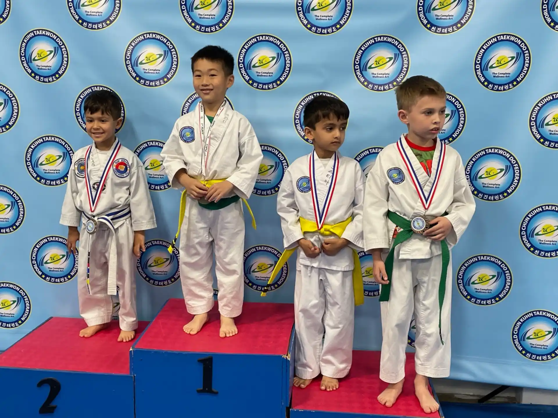 a group of boys in karate uniforms