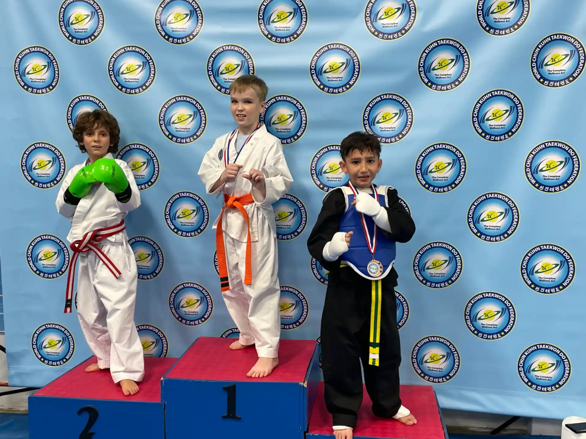 a group of kids in karate uniforms