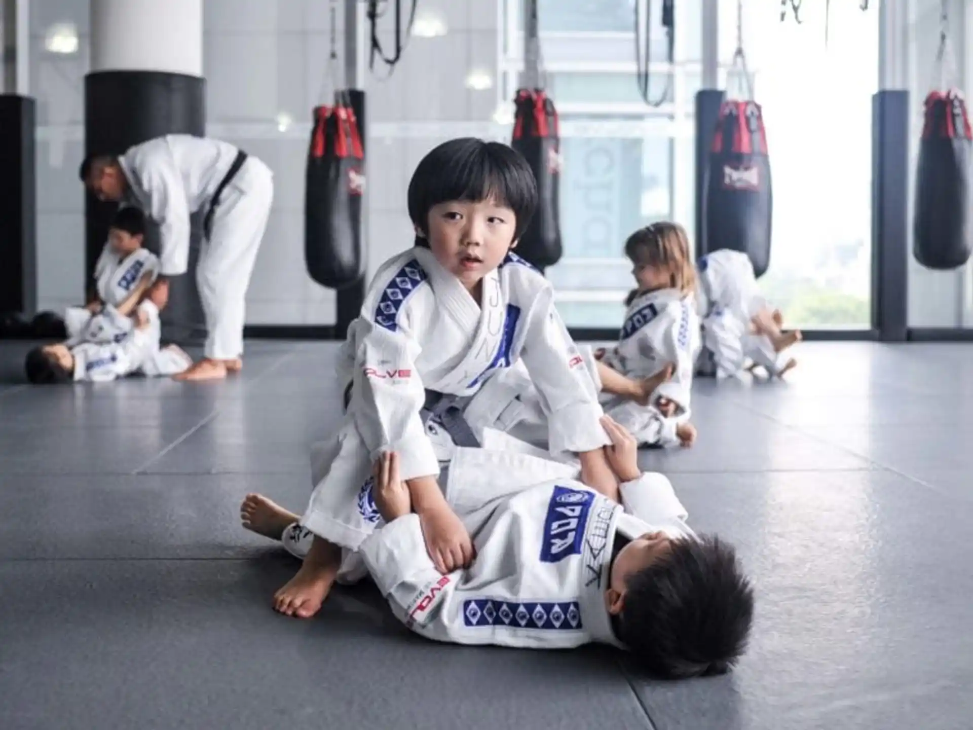 a group of children in karate uniforms