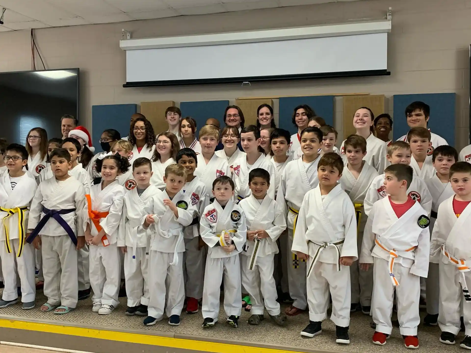 a group of people in white karate uniforms