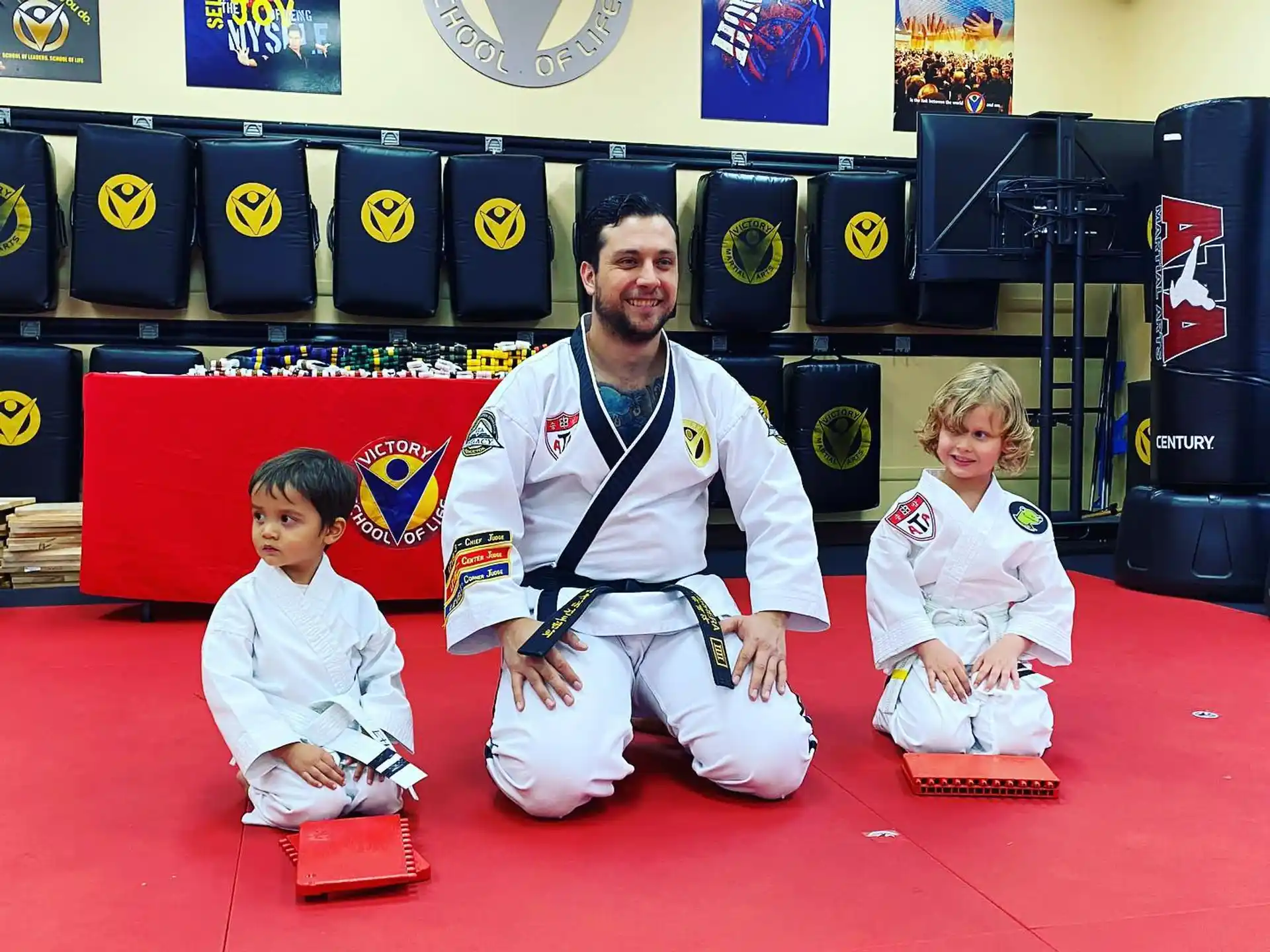 a man and two children sitting on a red carpet