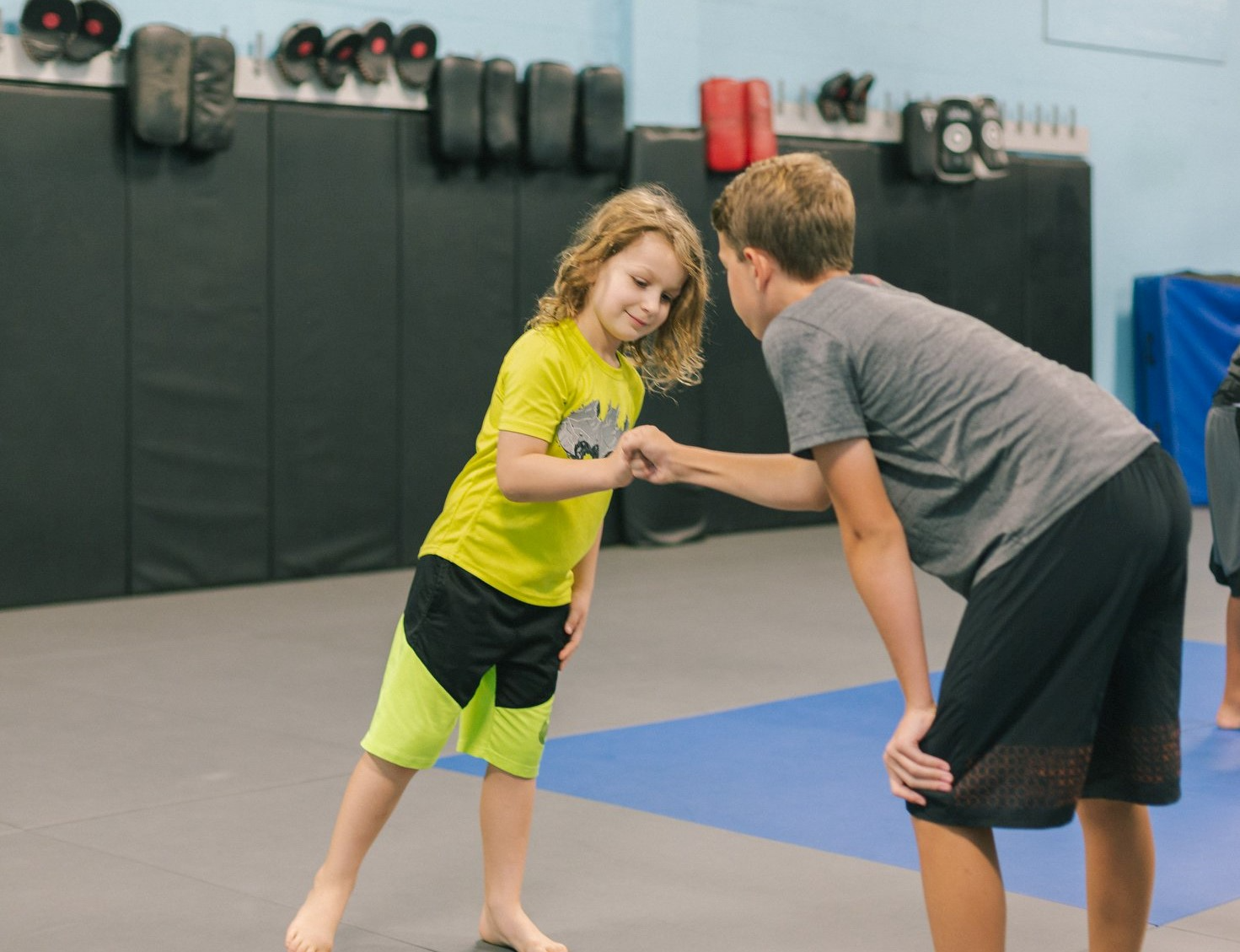 a person and a boy in a gym
