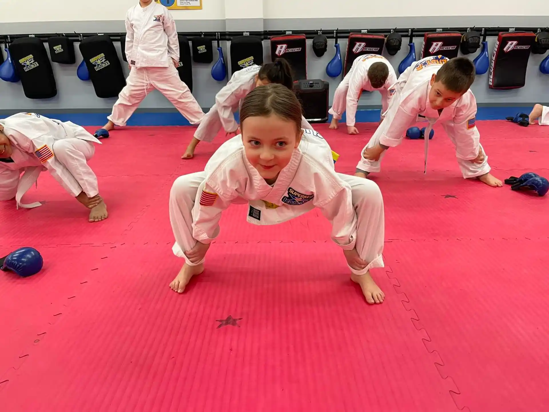 a group of kids in karate uniforms