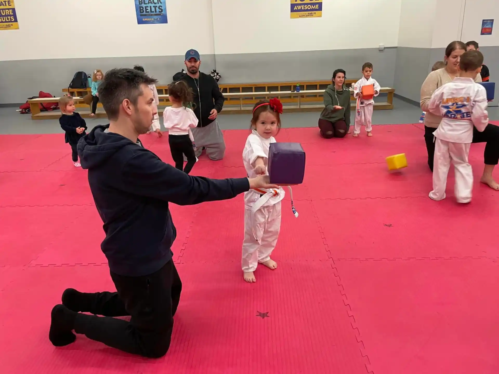 a person and a girl in karate uniforms